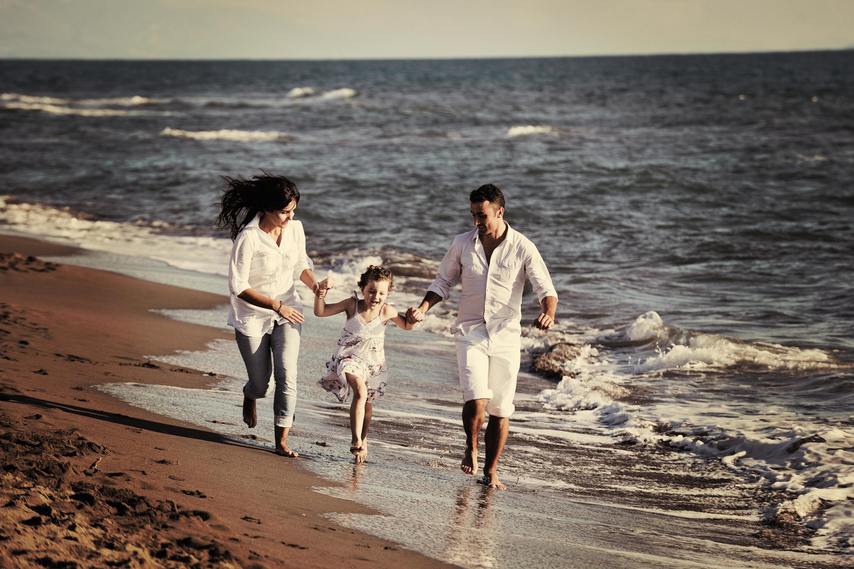 happy young family have fun on beach Stock Free