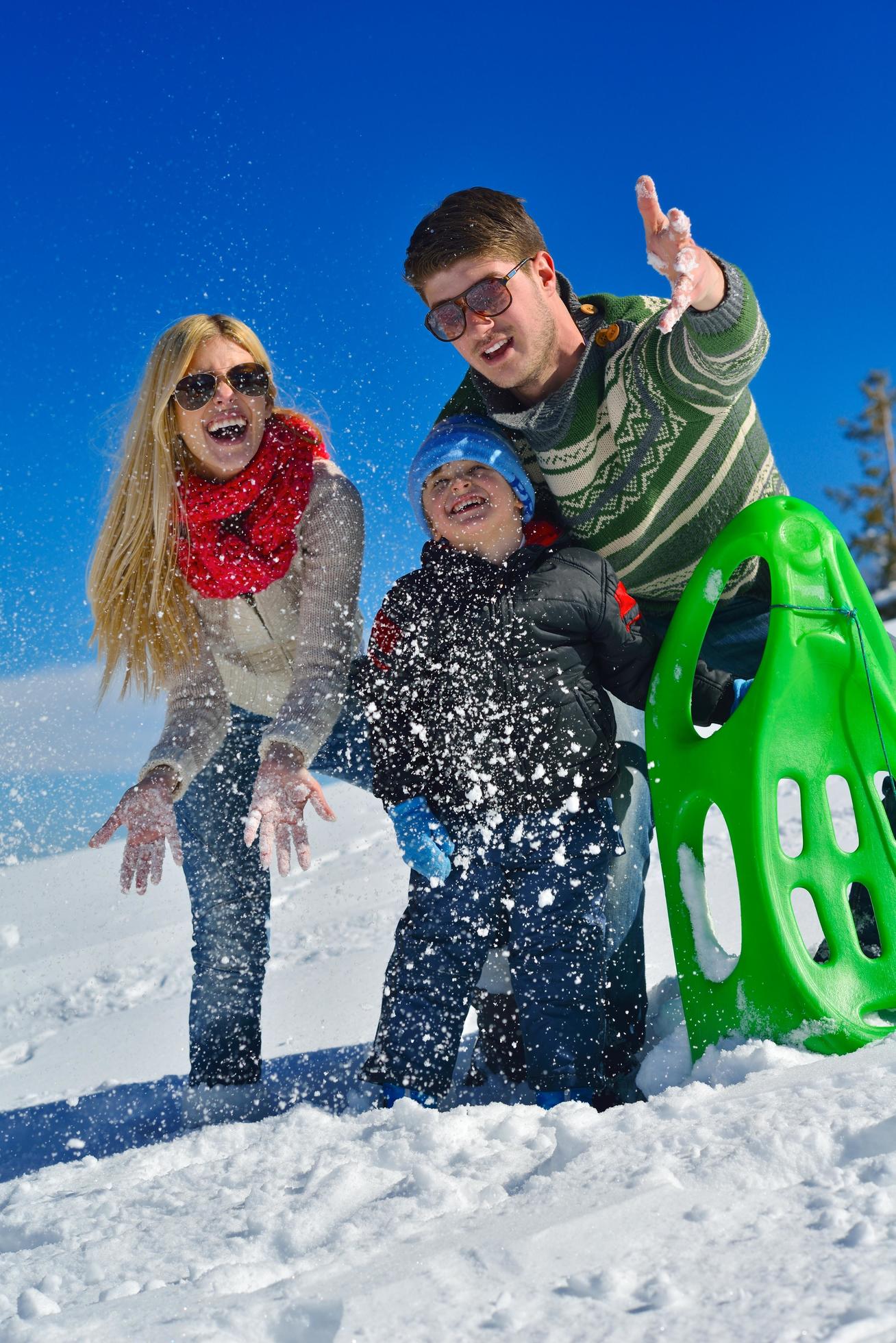 family having fun on fresh snow at winter Stock Free