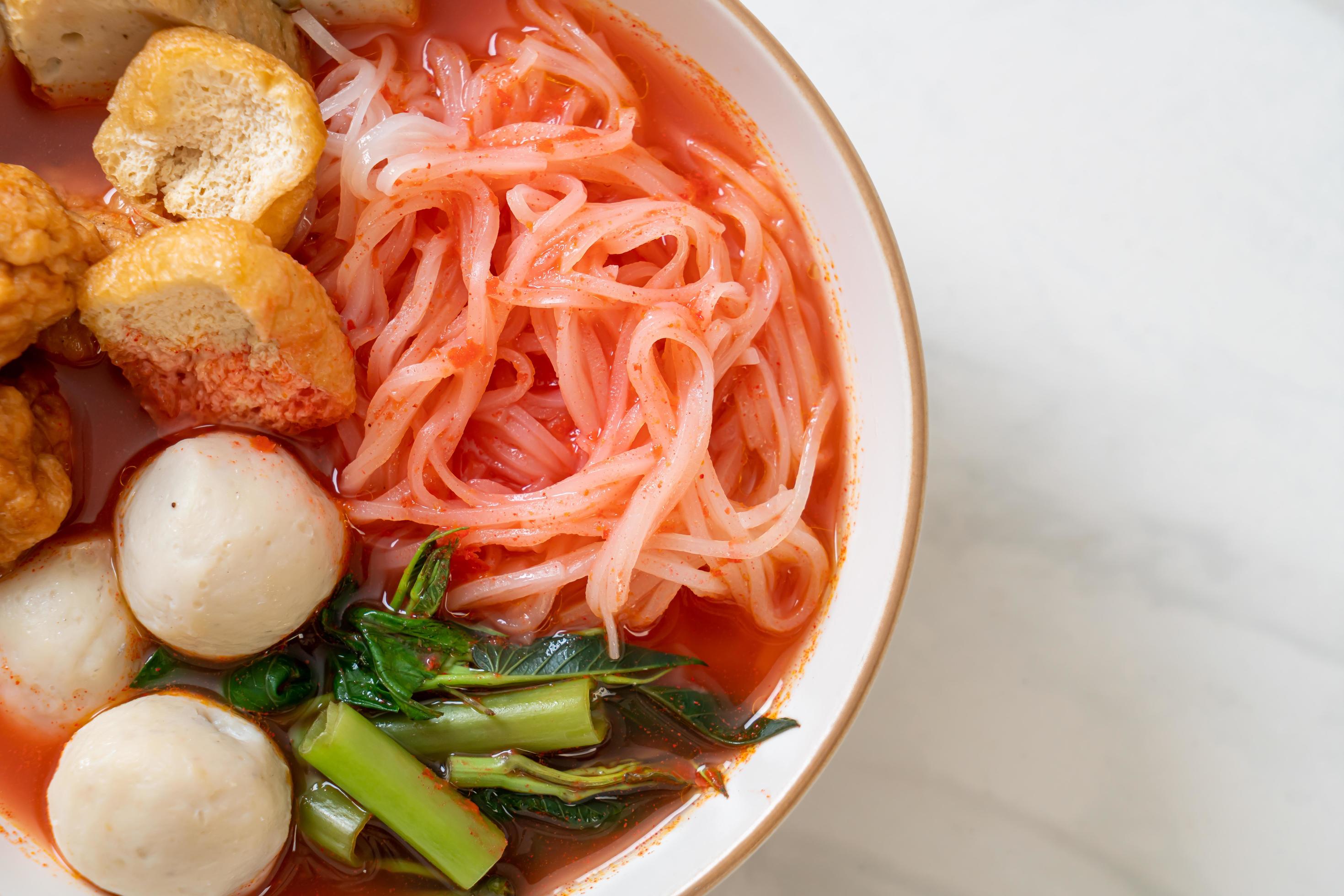 Small flat rice noodles with fish balls and shrimp balls in pink soup, Yen Ta Four or Yen Ta Fo – Asian food style Stock Free