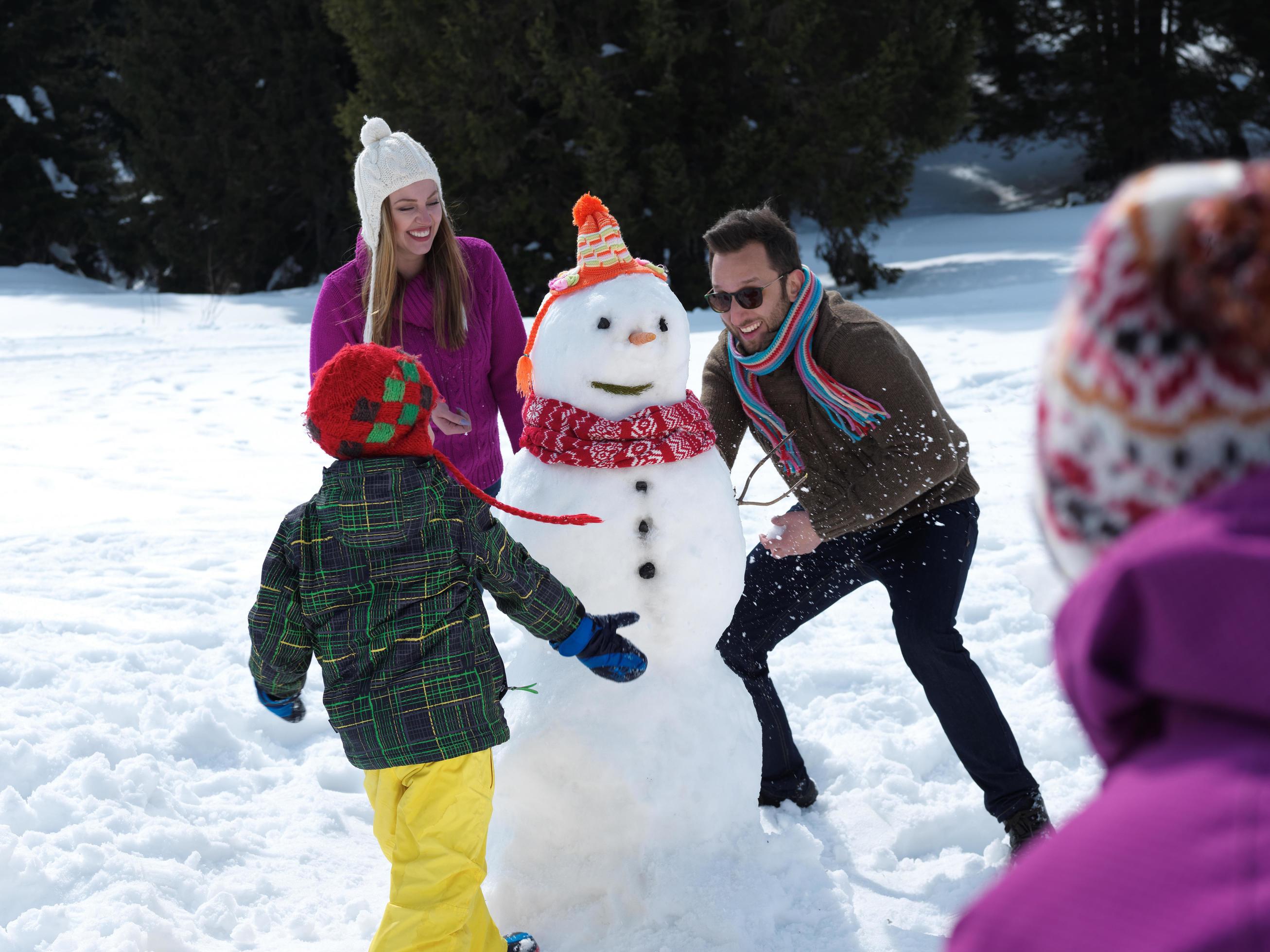 happy family making snowman Stock Free