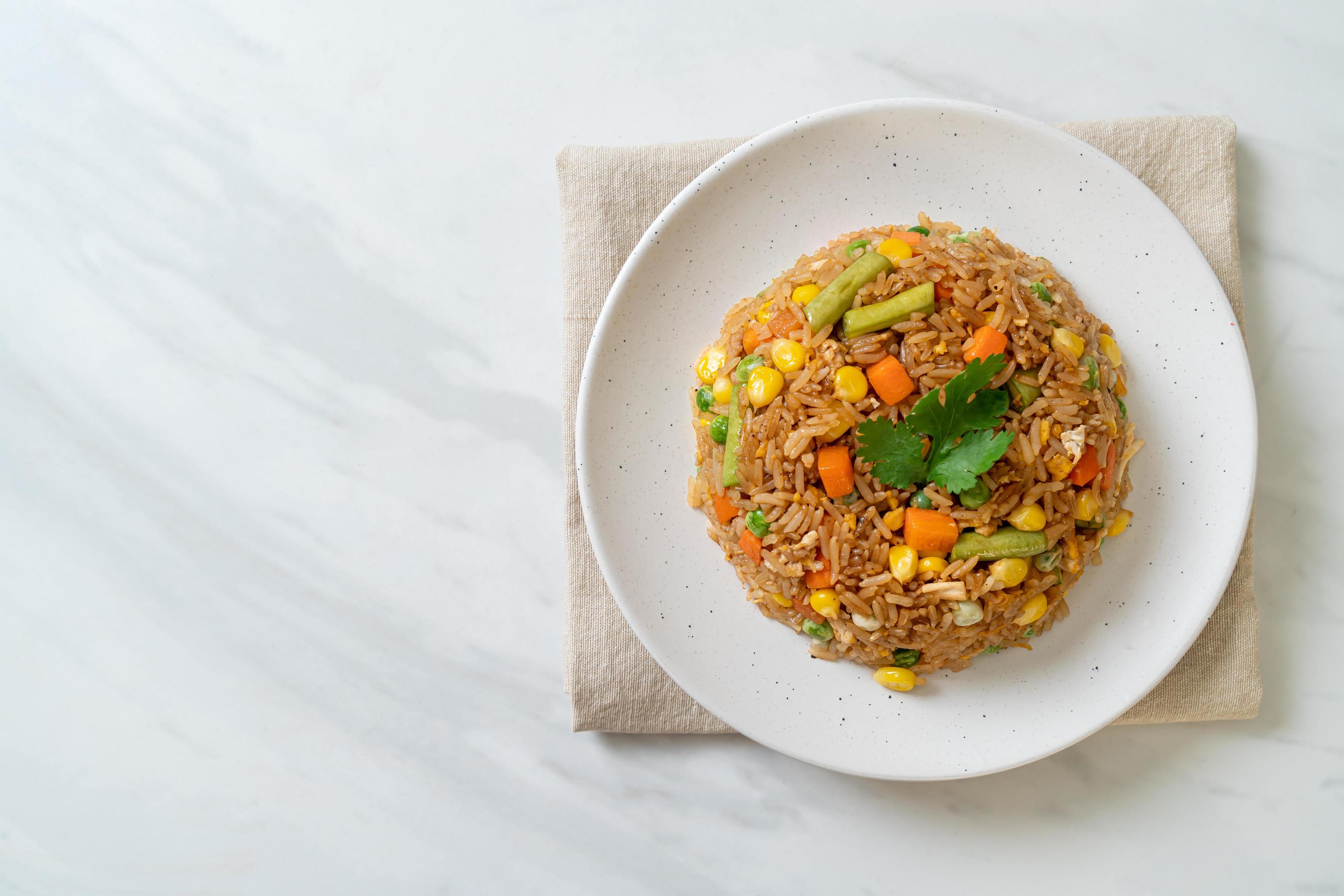 Fried rice with green peas, carrot and corn – vegetarian and healthy food style Stock Free