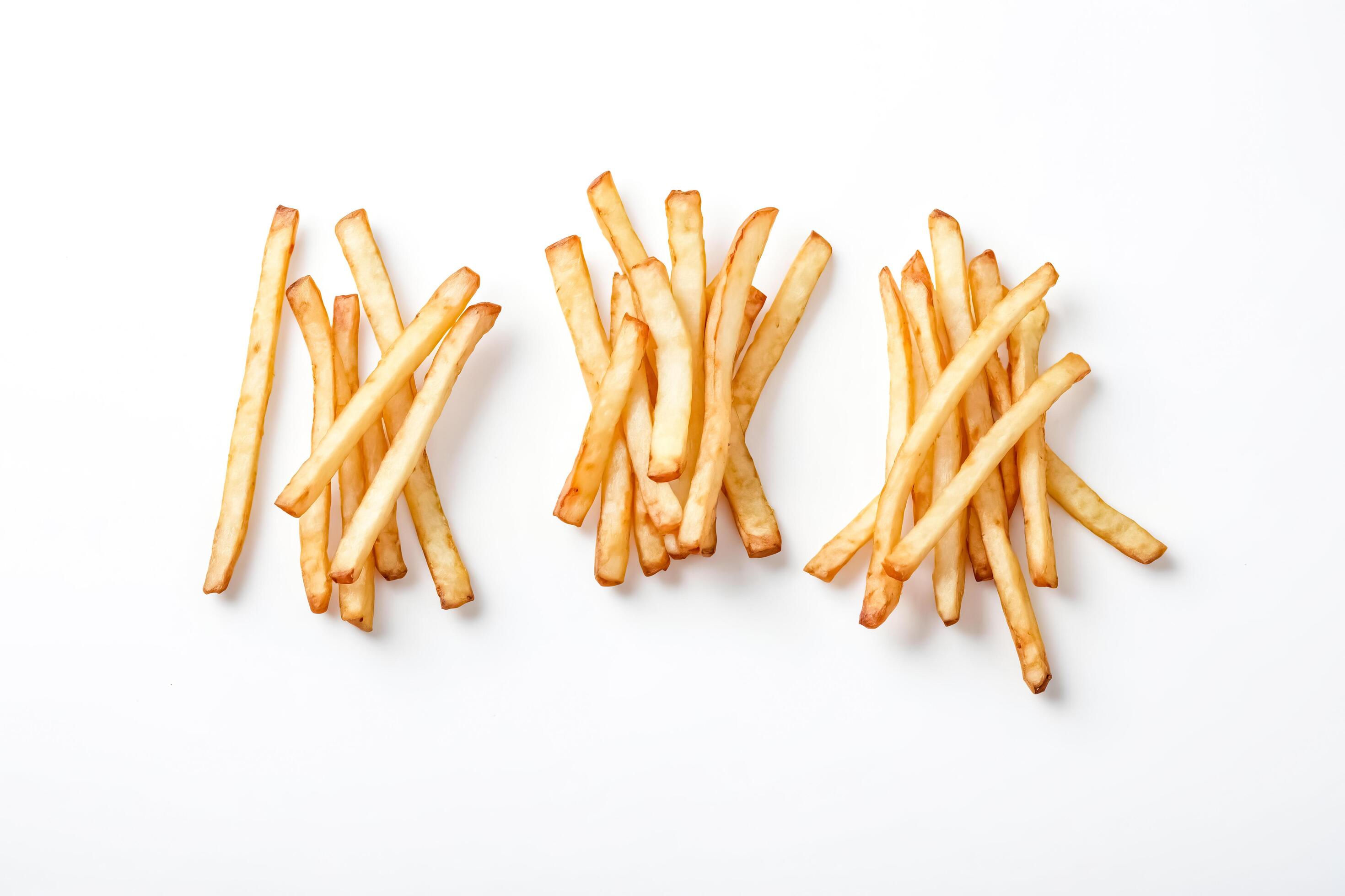 Three Groups of Golden French Fries on White Background Stock Free