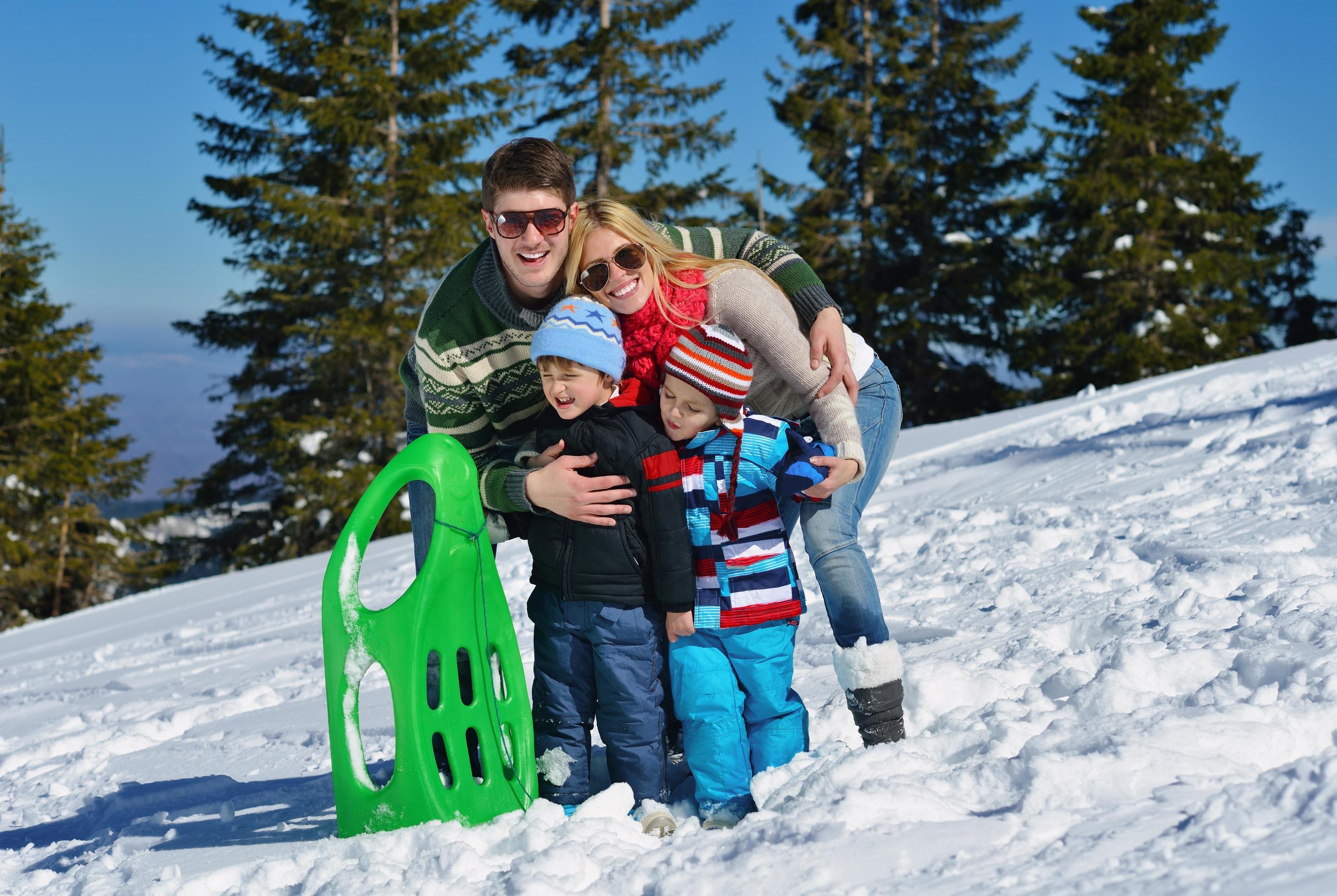 family having fun on fresh snow at winter Stock Free