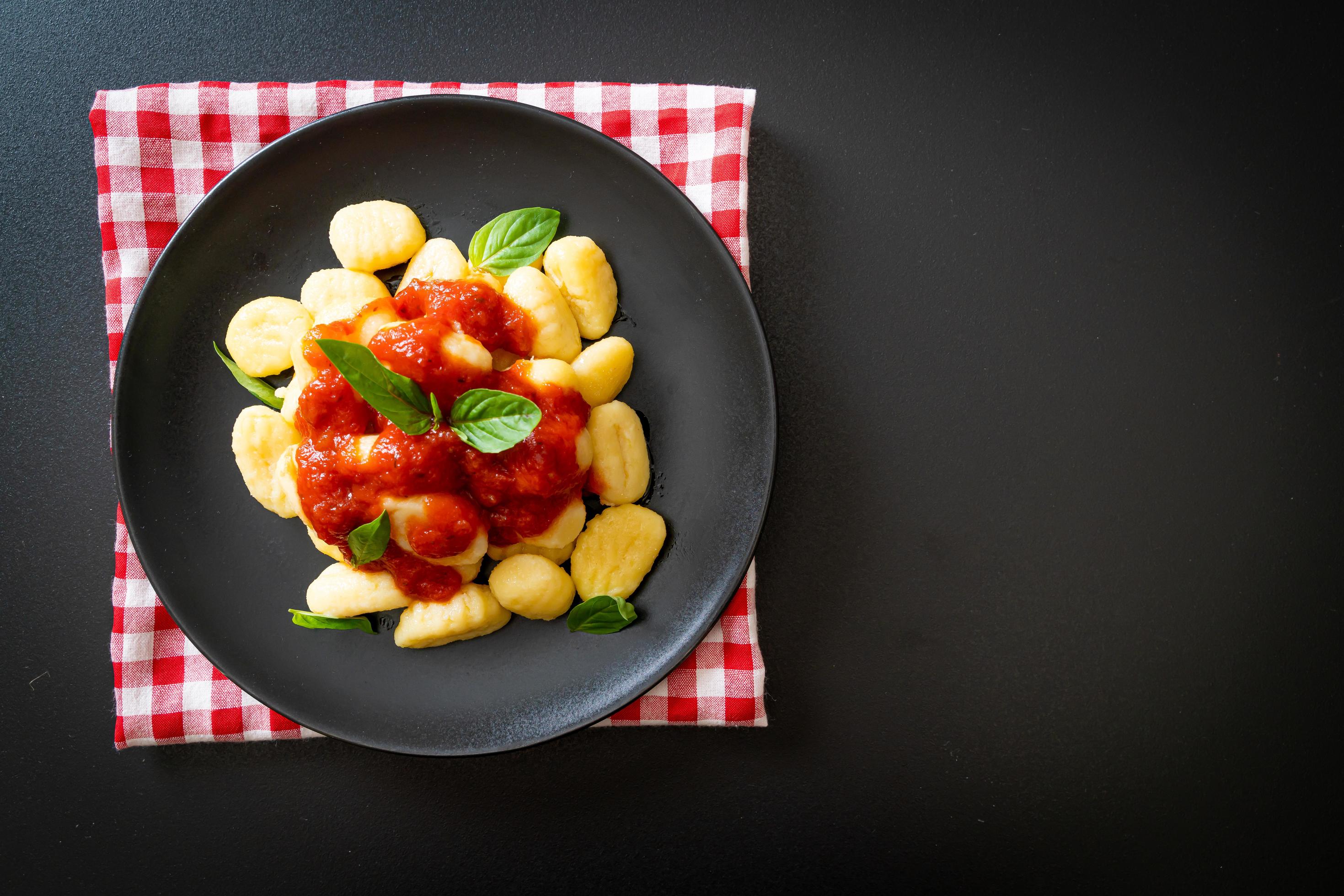 Gnocchi in tomato sauce with cheese – Italian food style Stock Free