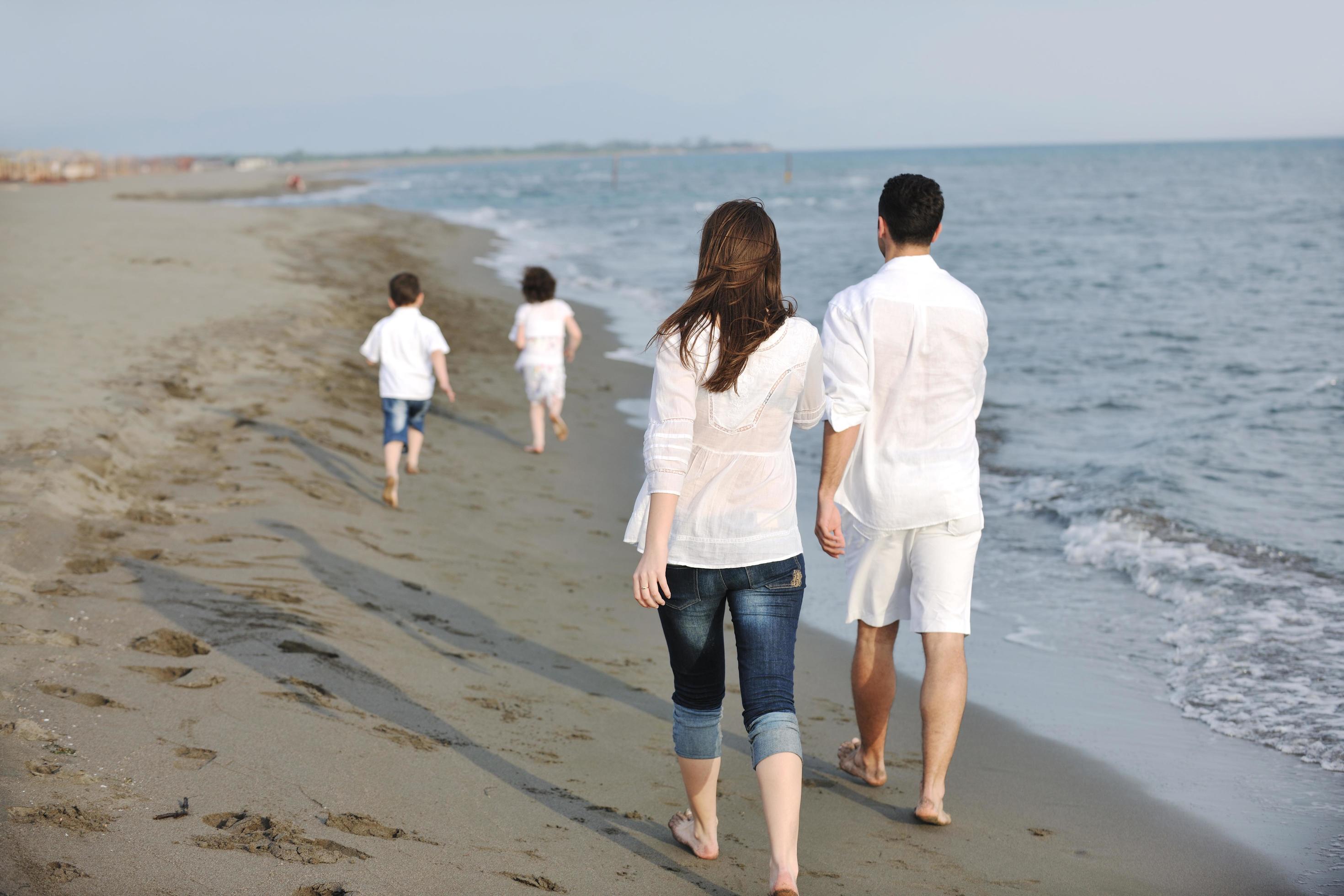 happy young family have fun on beach Stock Free