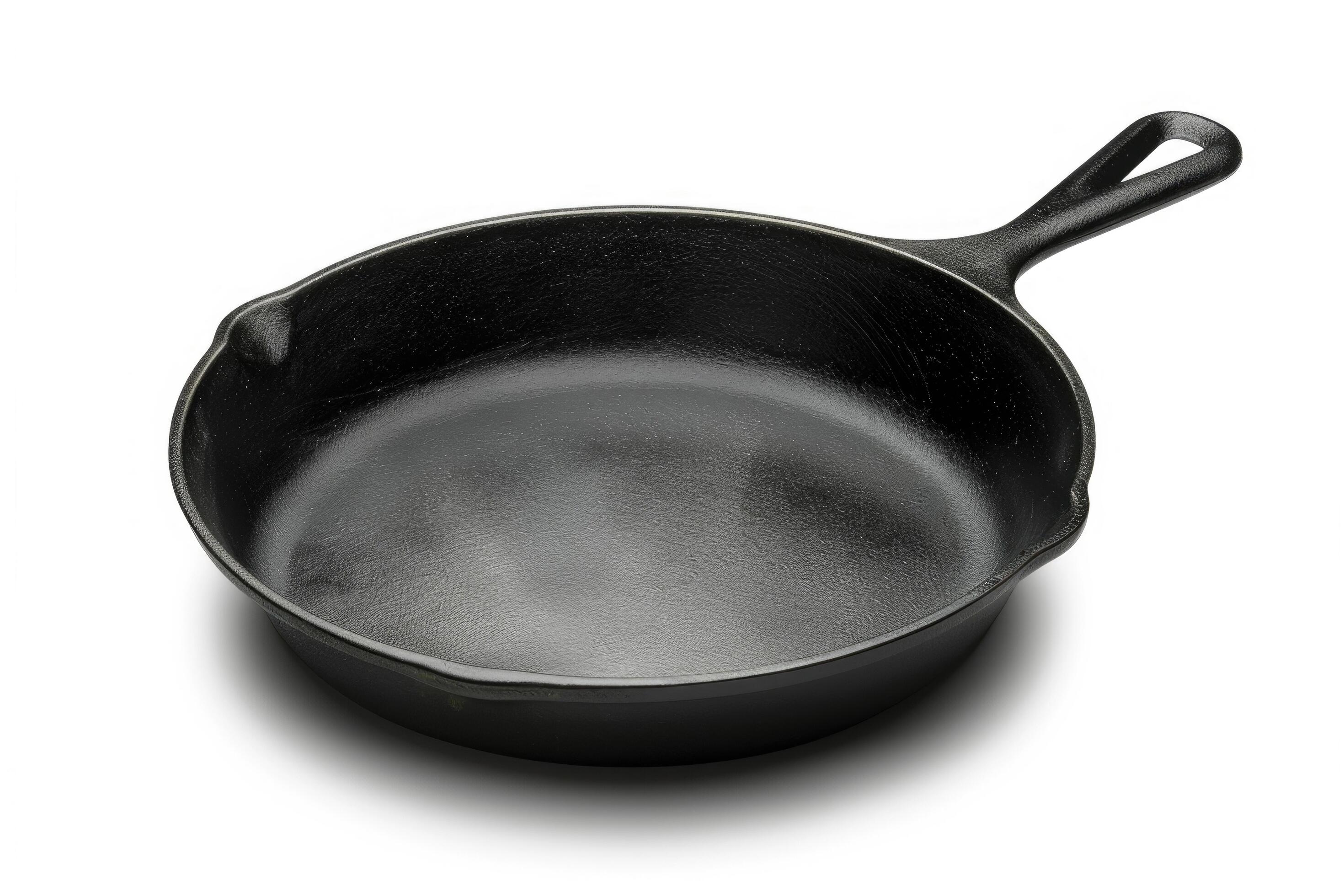 Black cast iron skillet on a white background. Stock Free