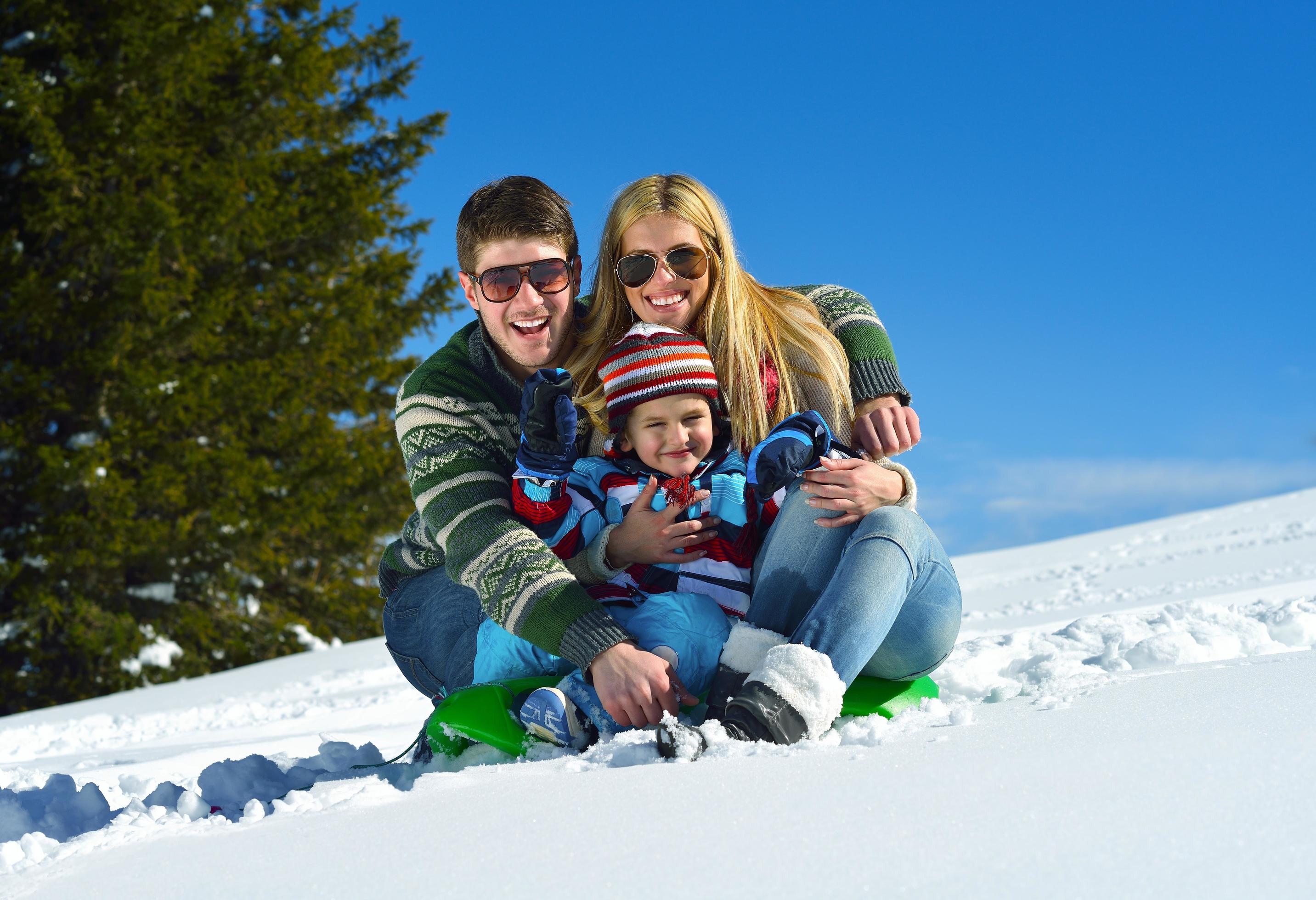 family having fun on fresh snow at winter Stock Free