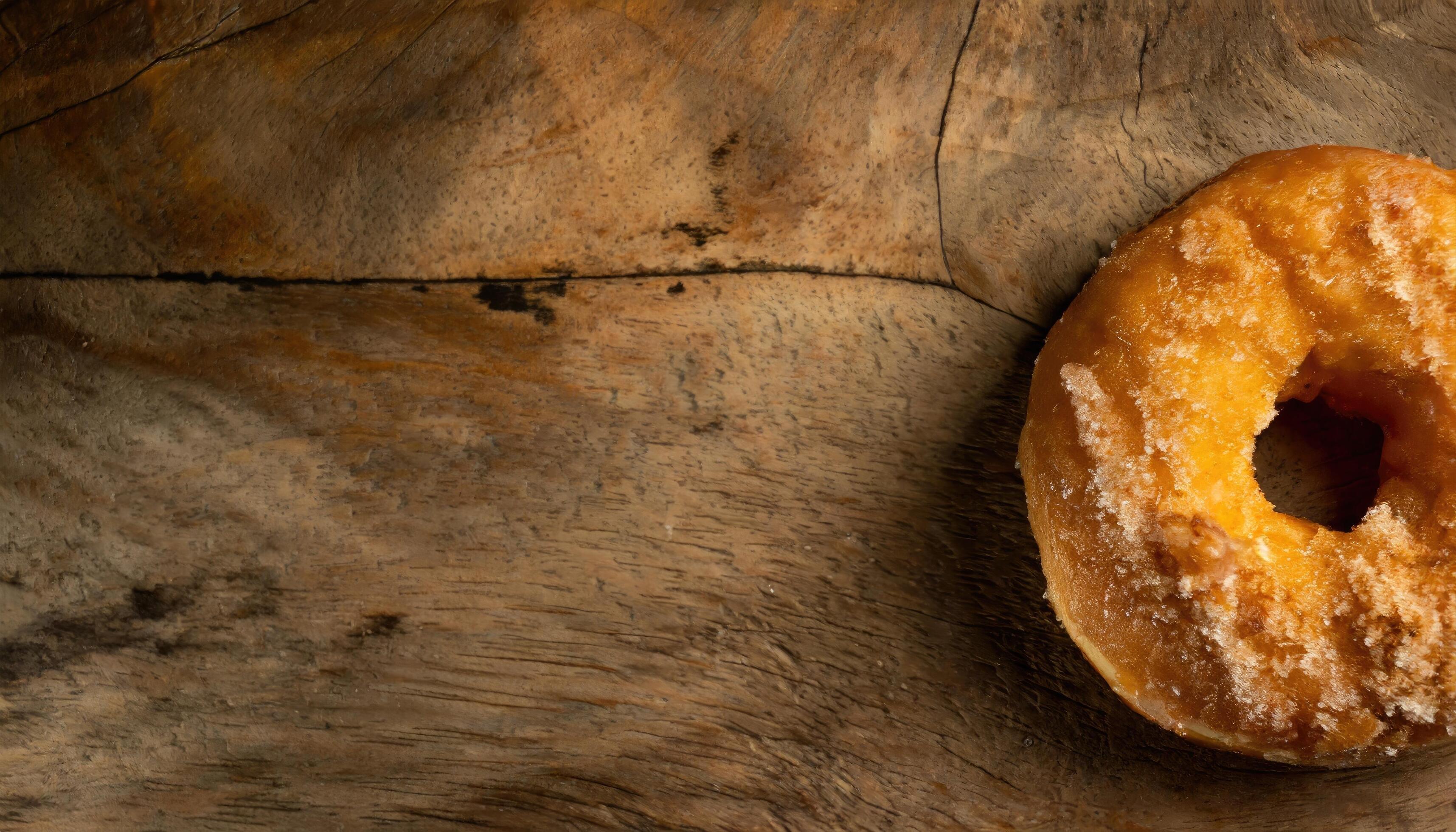 Copy Space image of Donuts with powdered sugar on wooden table on black background Stock Free