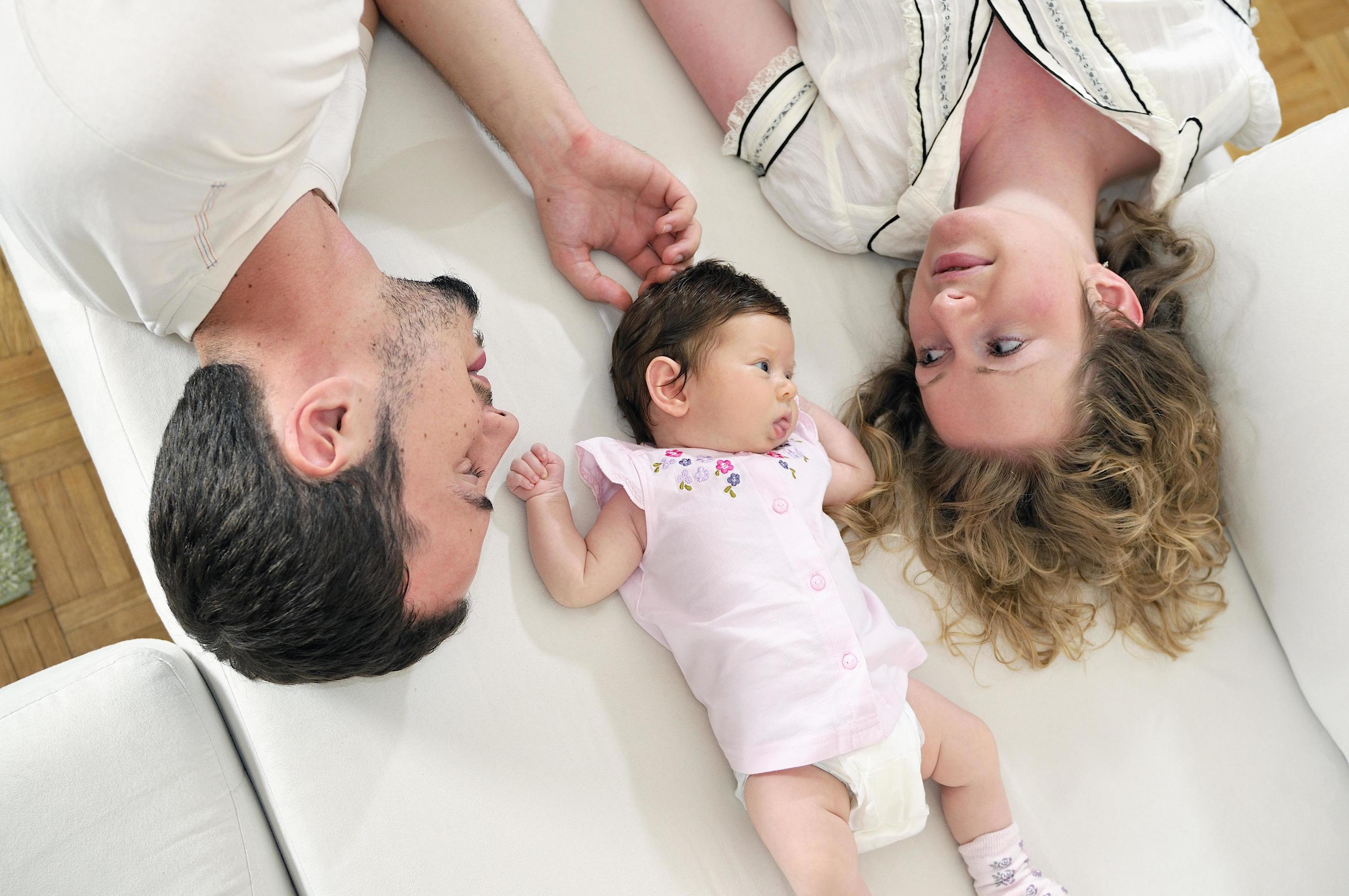 indoor portrait with happy young family and cute little babby Stock Free