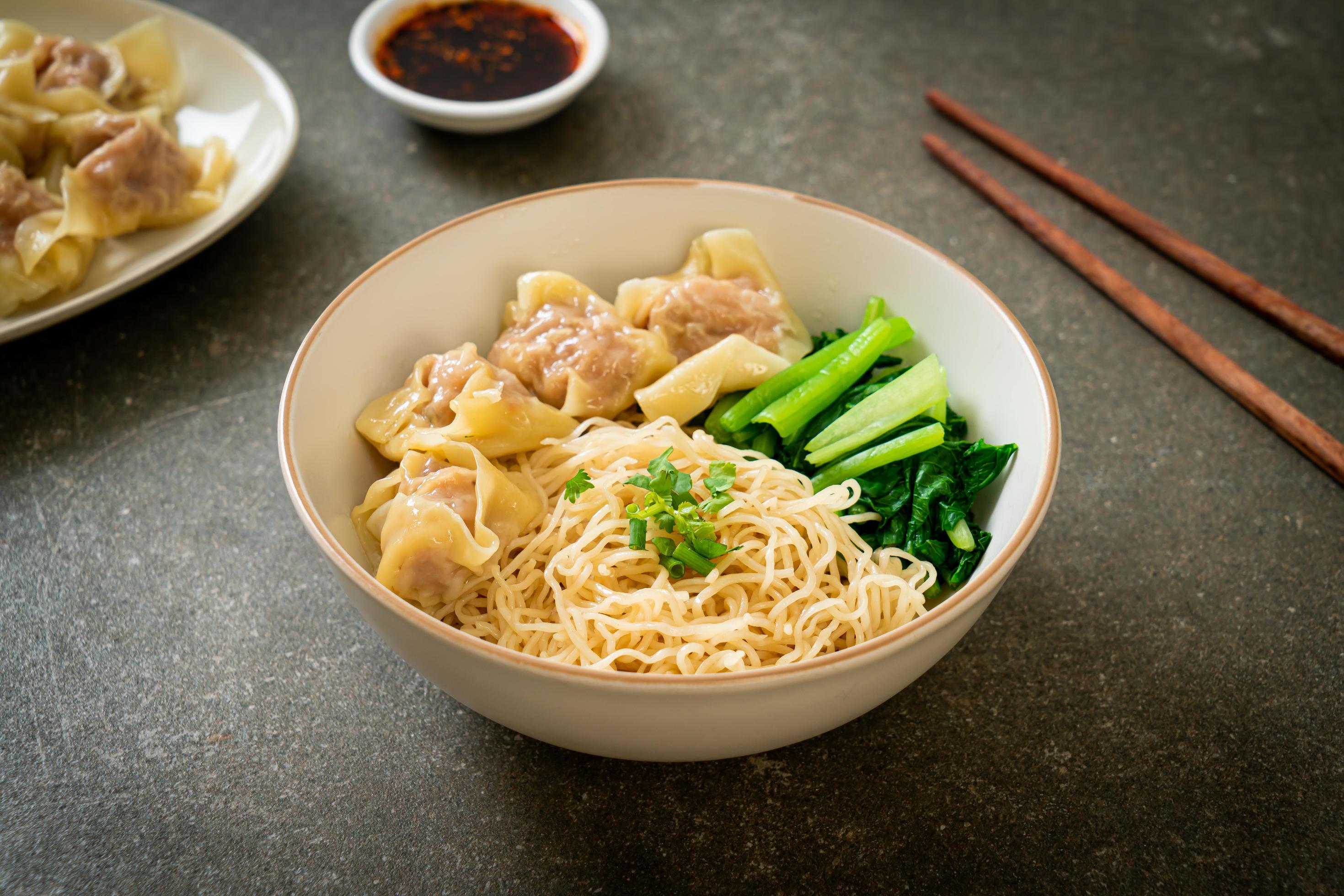 Dried egg noodles with pork wonton or pork dumplings without soup Asian food style Stock Free