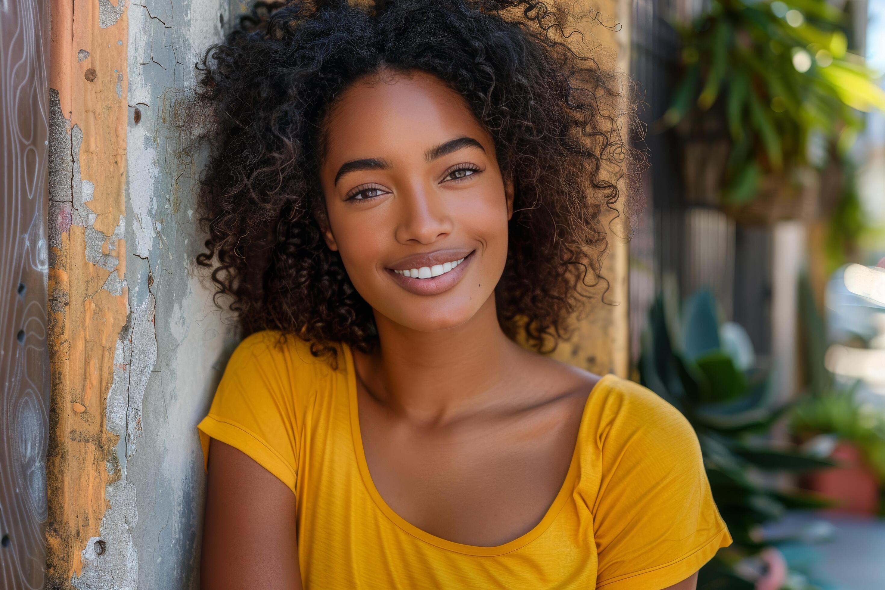 Smiling Woman With Dreadlocks in a Yellow Shirt on a Street in a City Stock Free