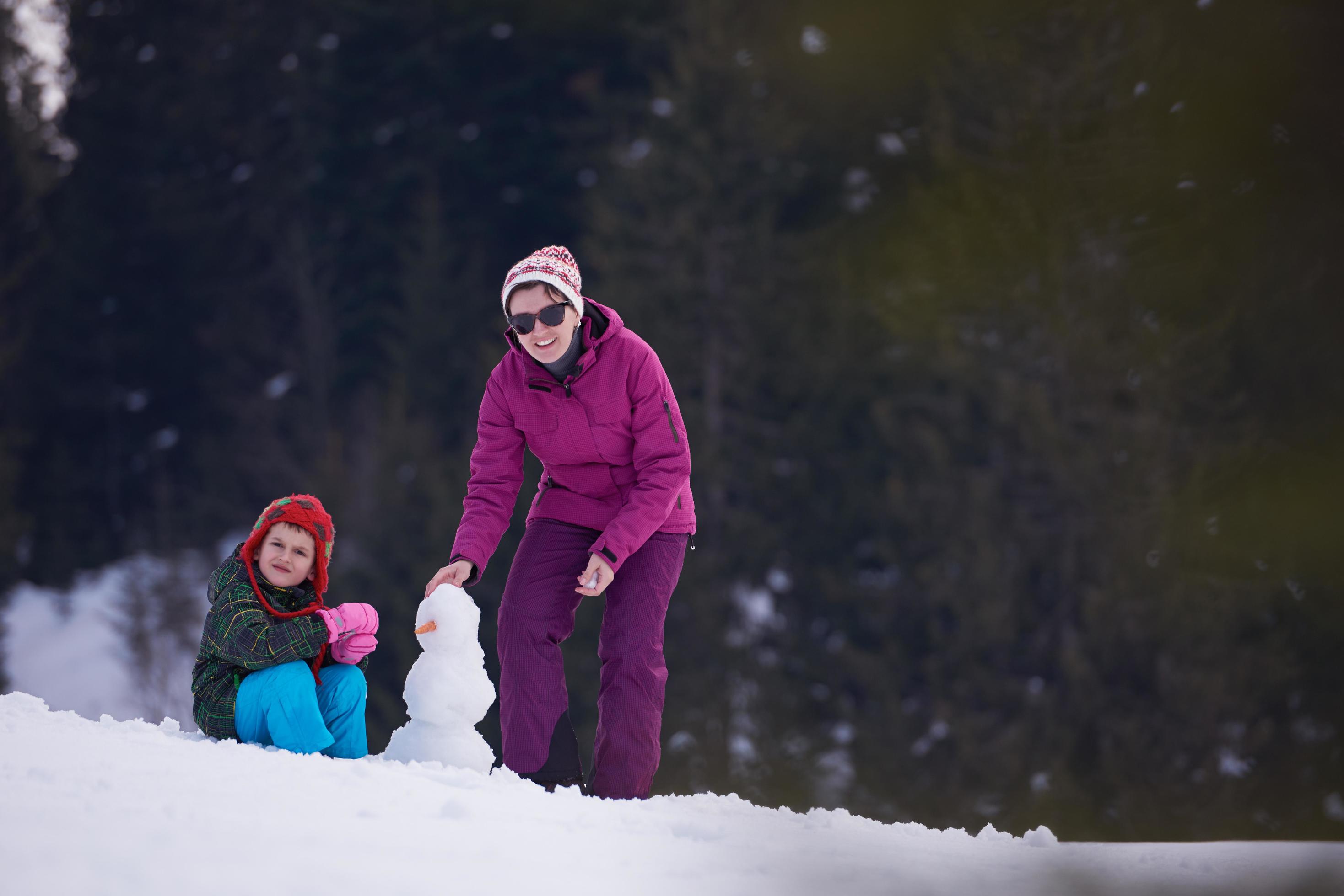 happy family building snowman Stock Free