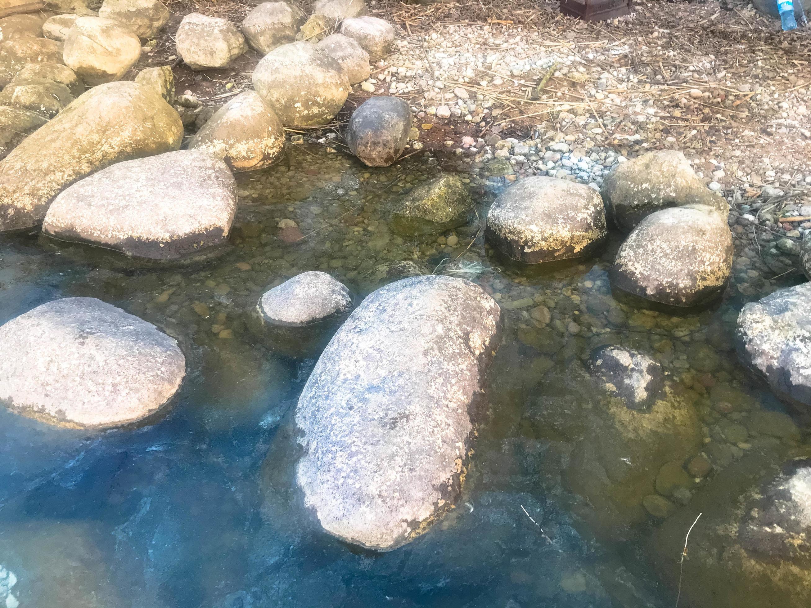 Large round beautiful natural stones cobblestones in water, sea, lake, river. Background, texture Stock Free