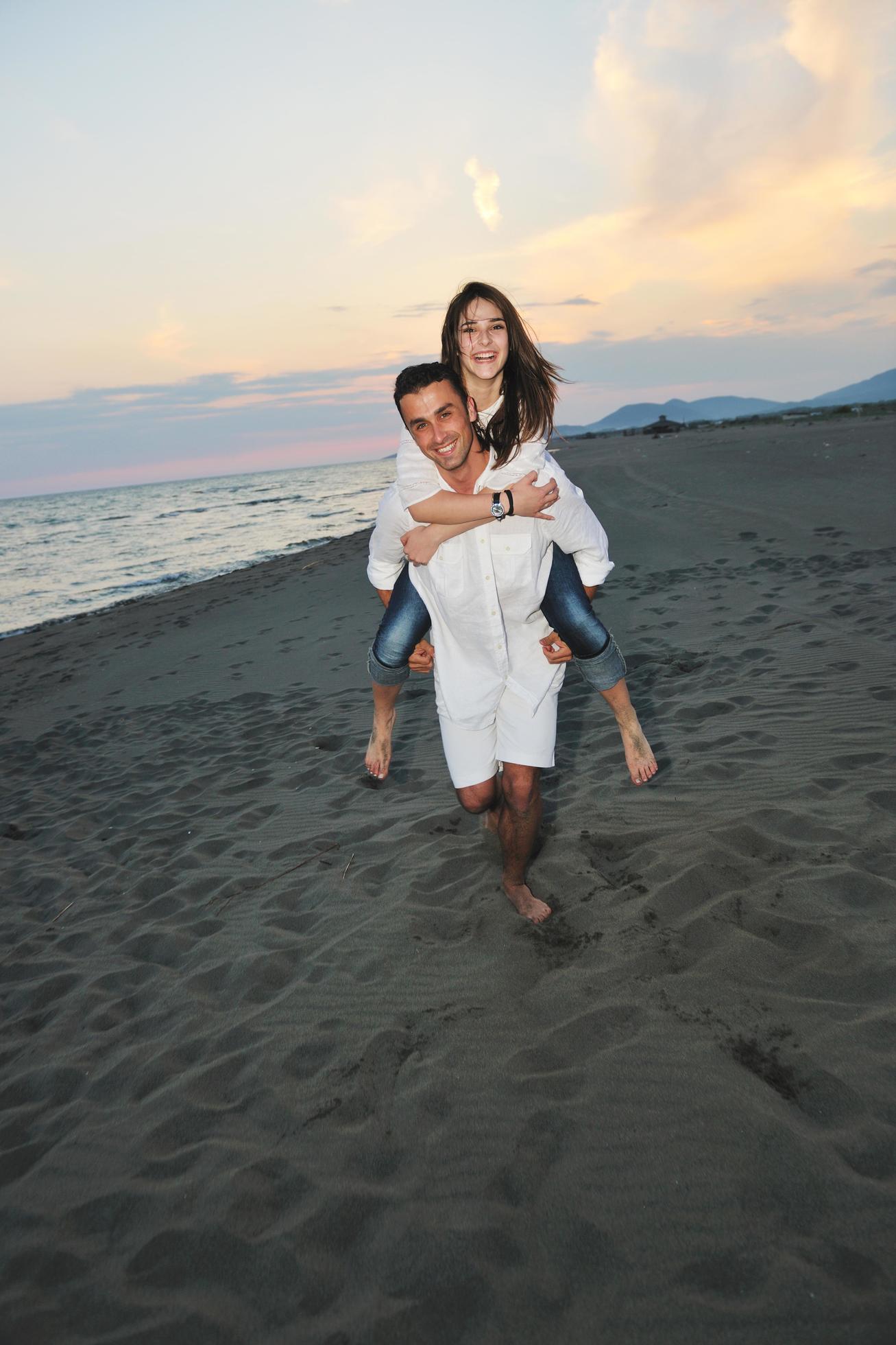 happy young couple have fun on beach Stock Free