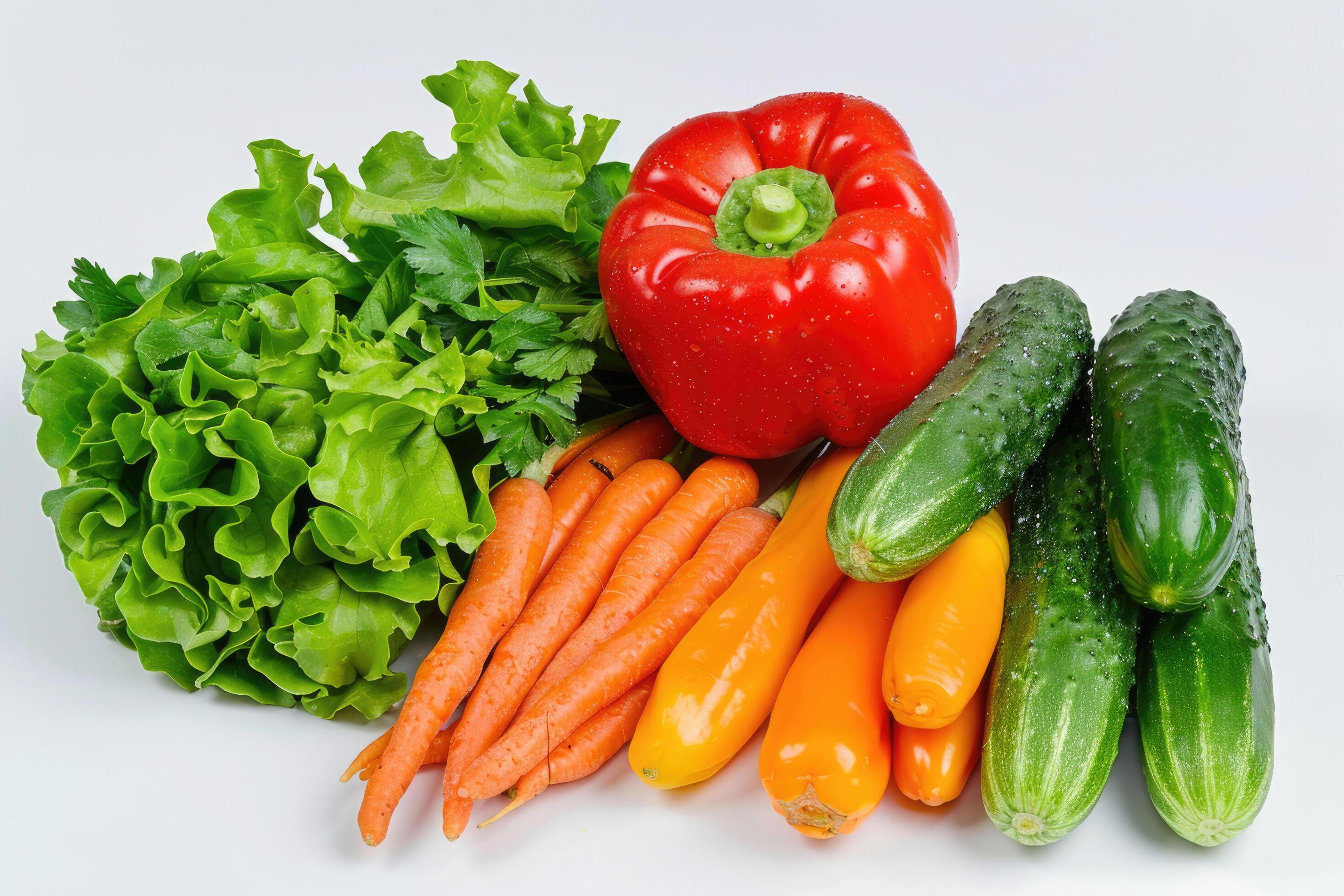 A colorful mix of fresh vegetables arranged on a white background Stock Free