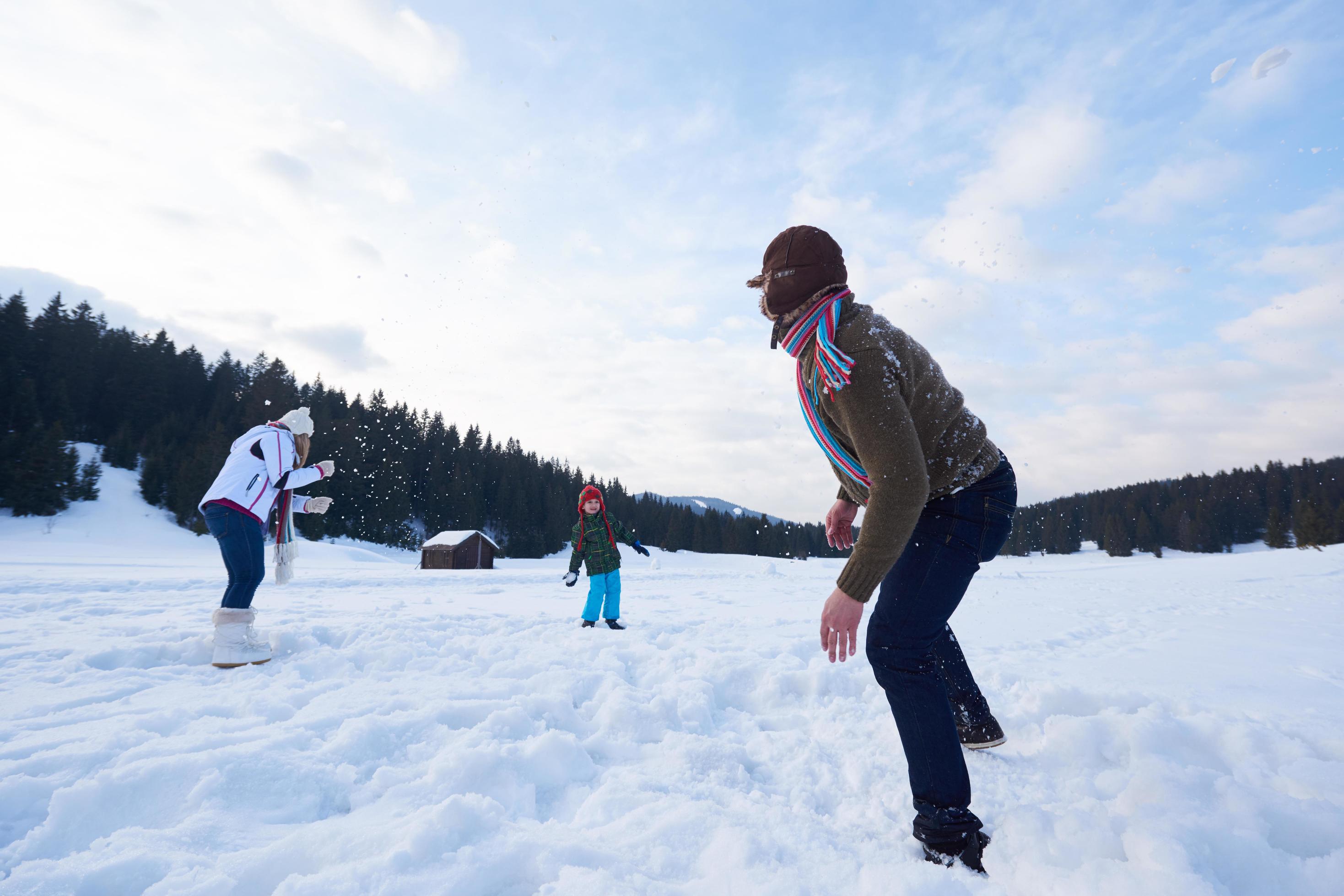 happy family playing together in snow at winter Stock Free