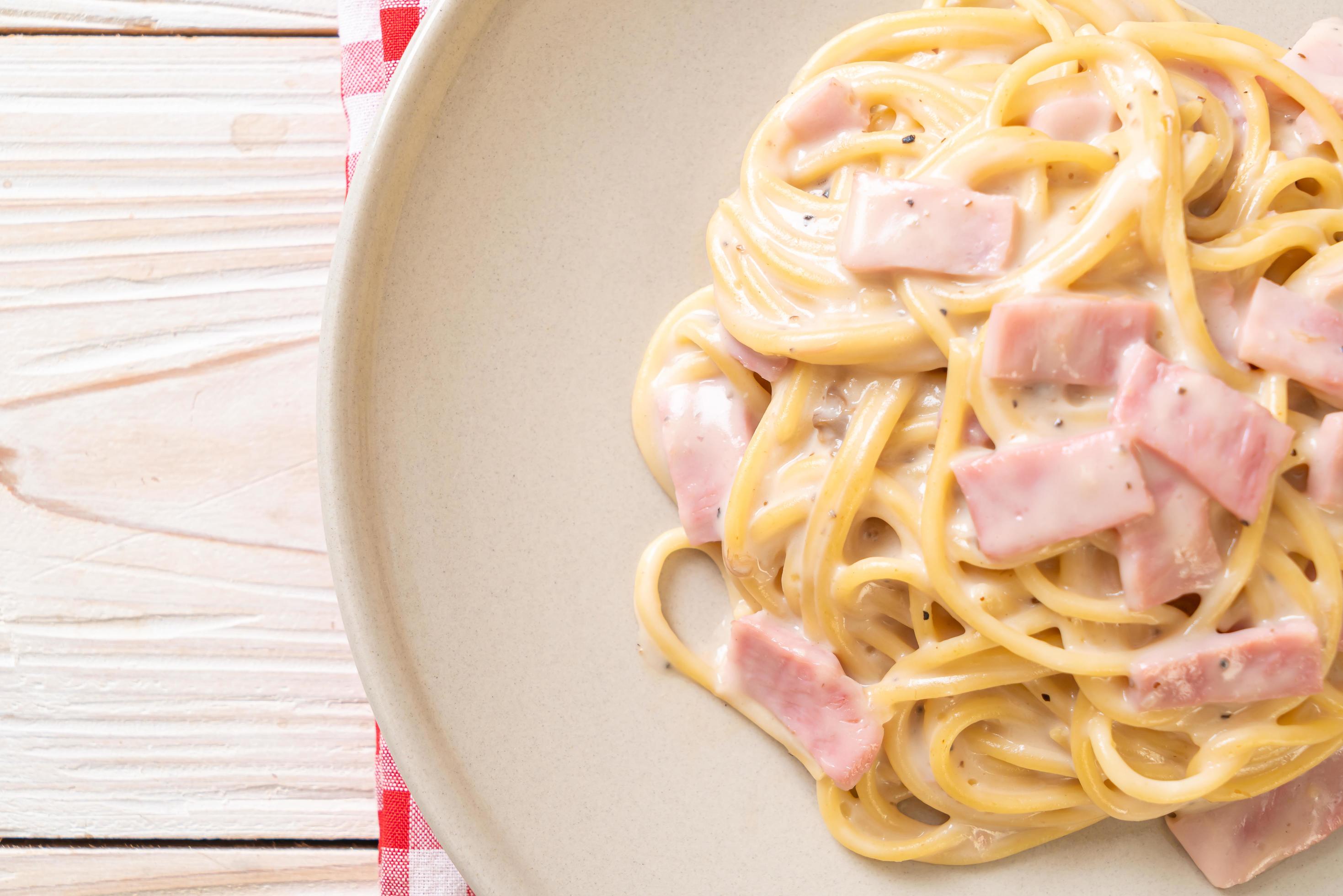 Homemade spaghetti white cream sauce with ham – Italian food style Stock Free