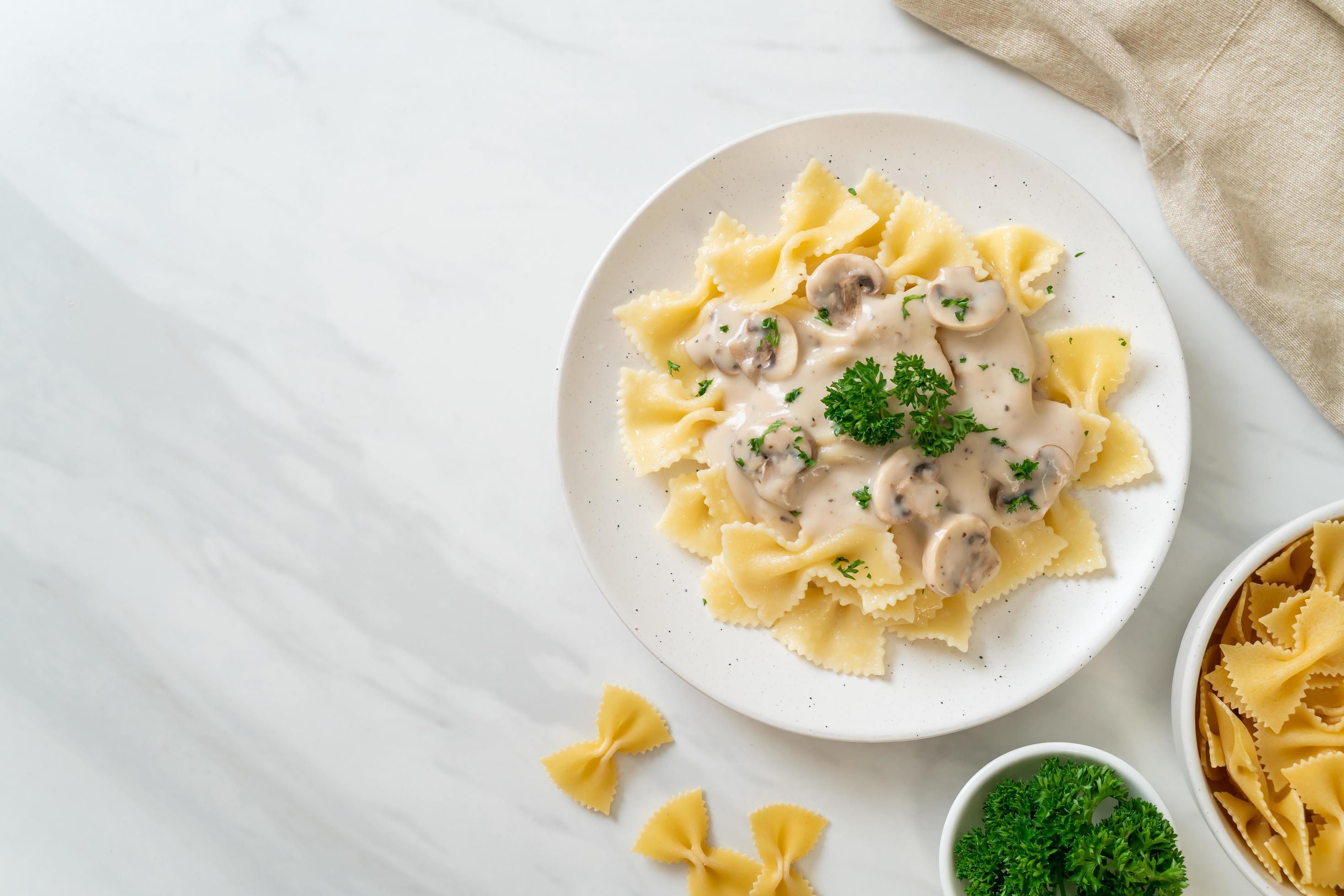 Farfalle pasta with mushroom white cream sauce – Italian food style Stock Free