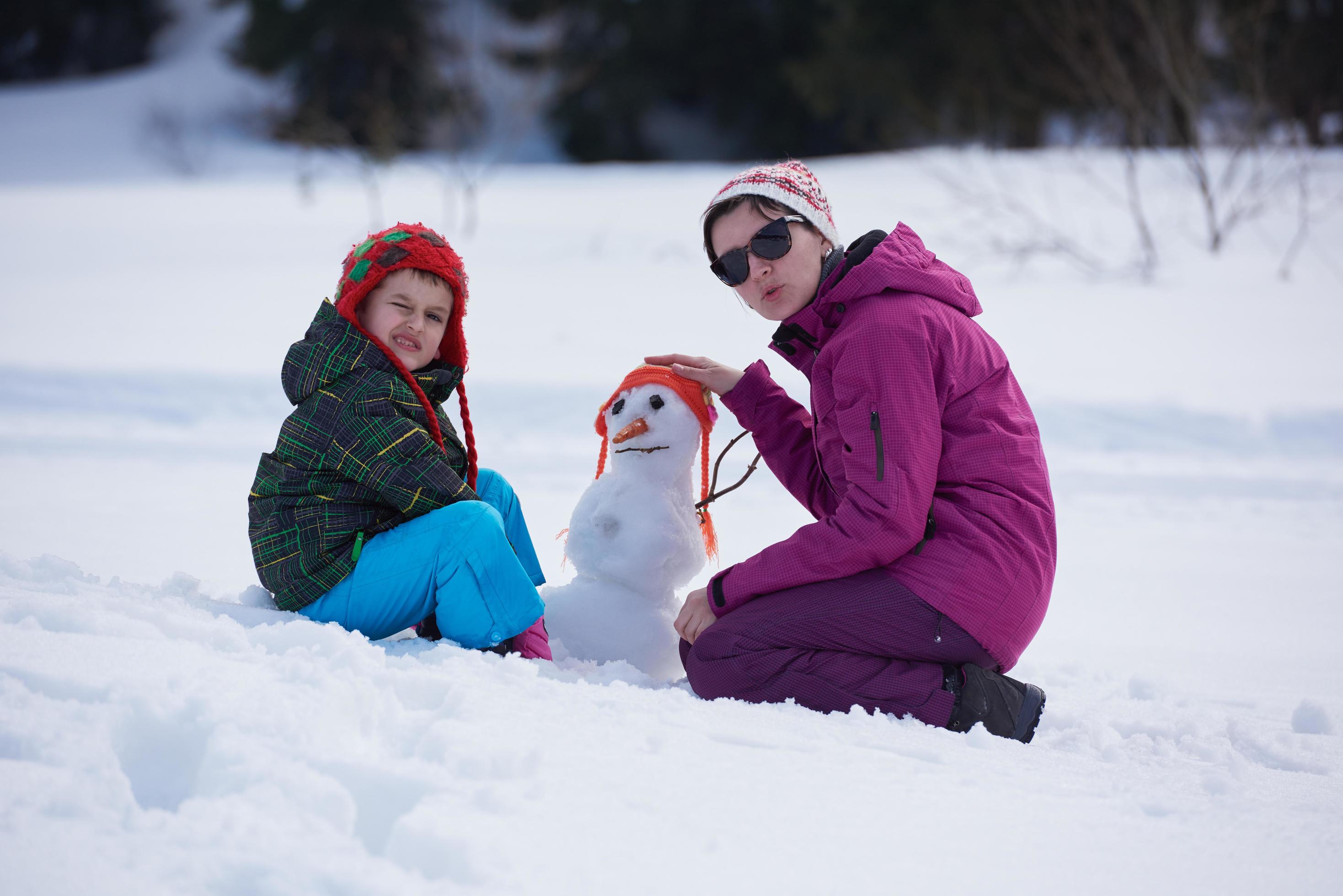 happy family building snowman Stock Free