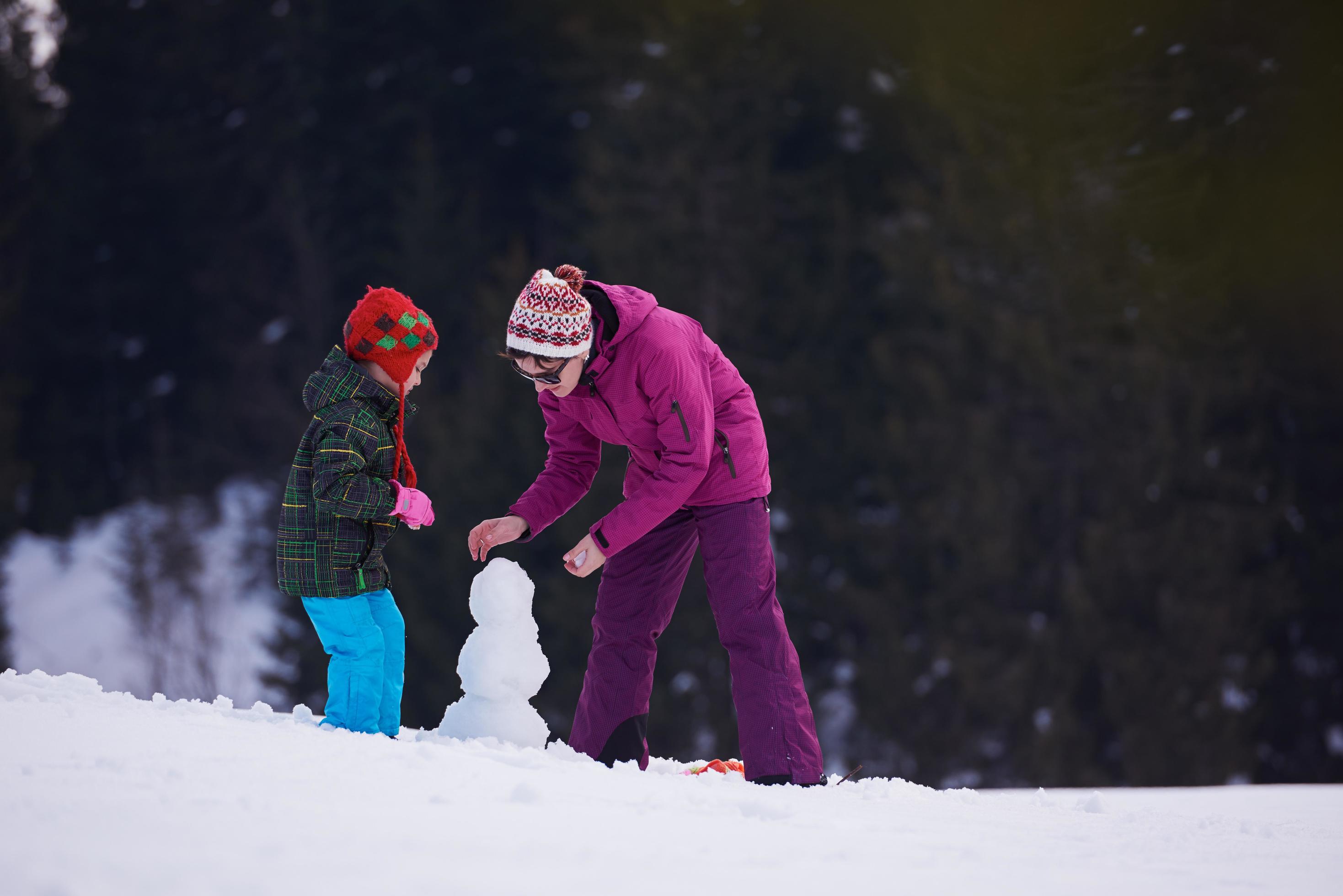 happy family building snowman Stock Free