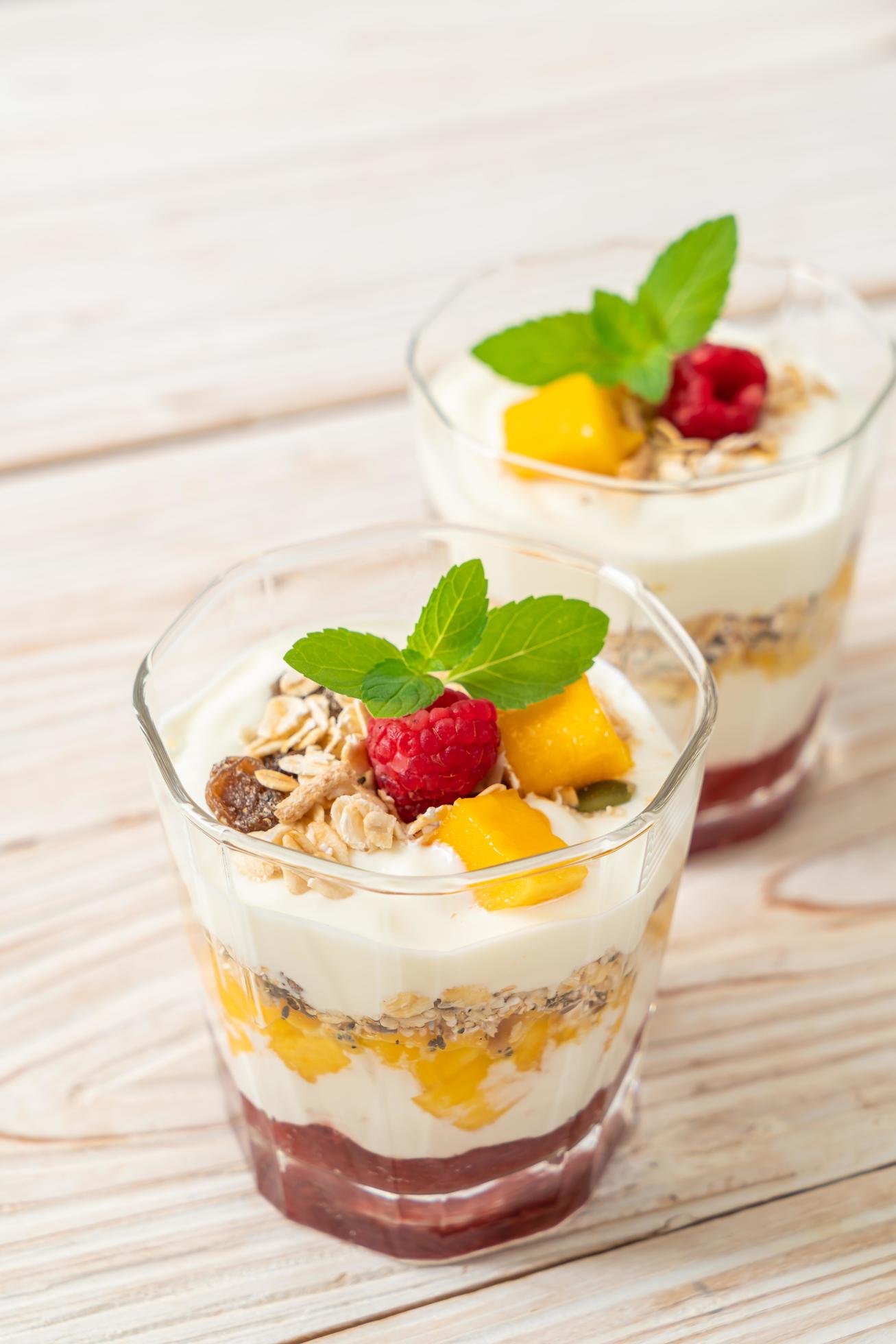 Homemade fresh mango and fresh raspberry with yogurt and granola – healthy food style Stock Free