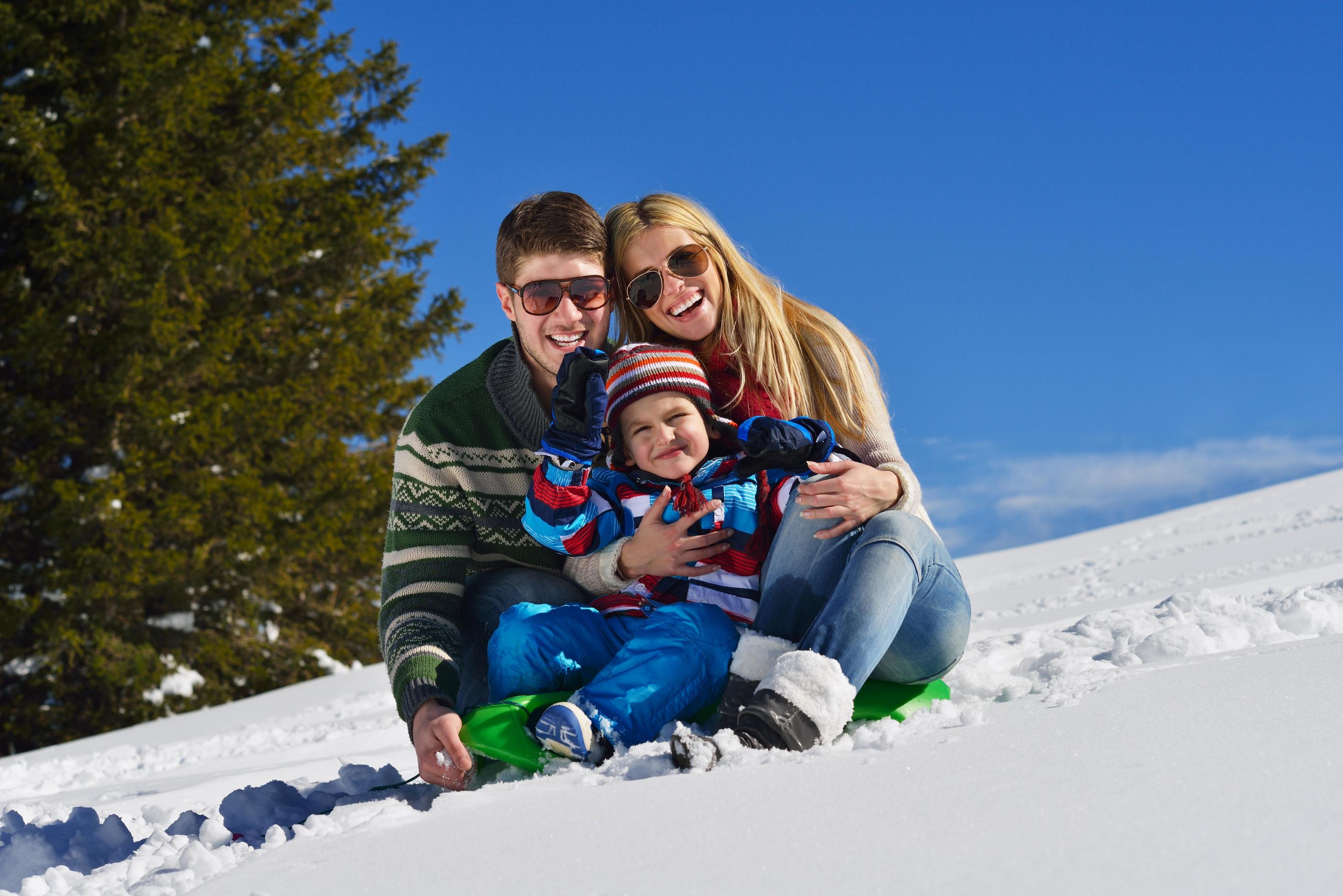 family having fun on fresh snow at winter Stock Free