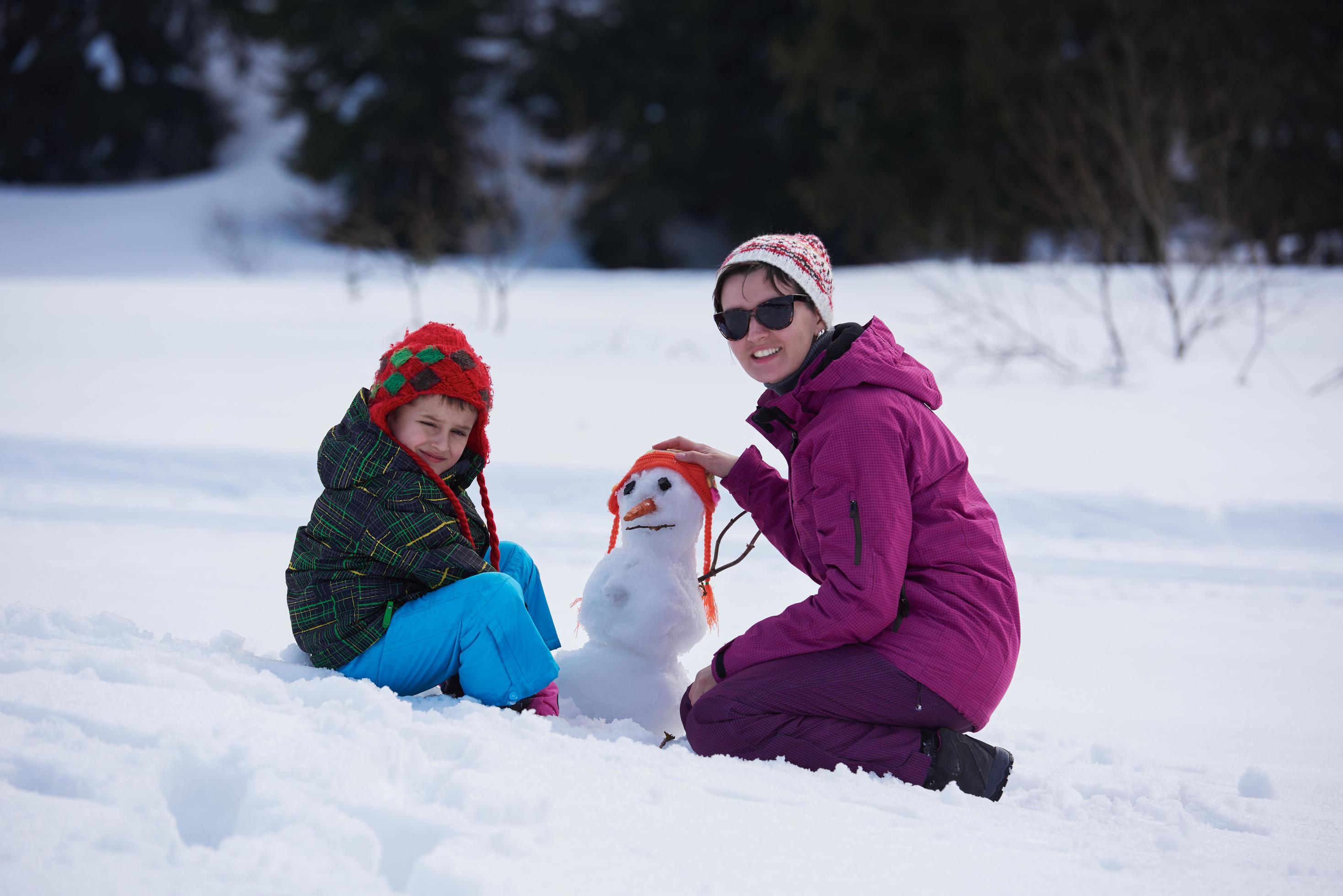 happy family building snowman Stock Free