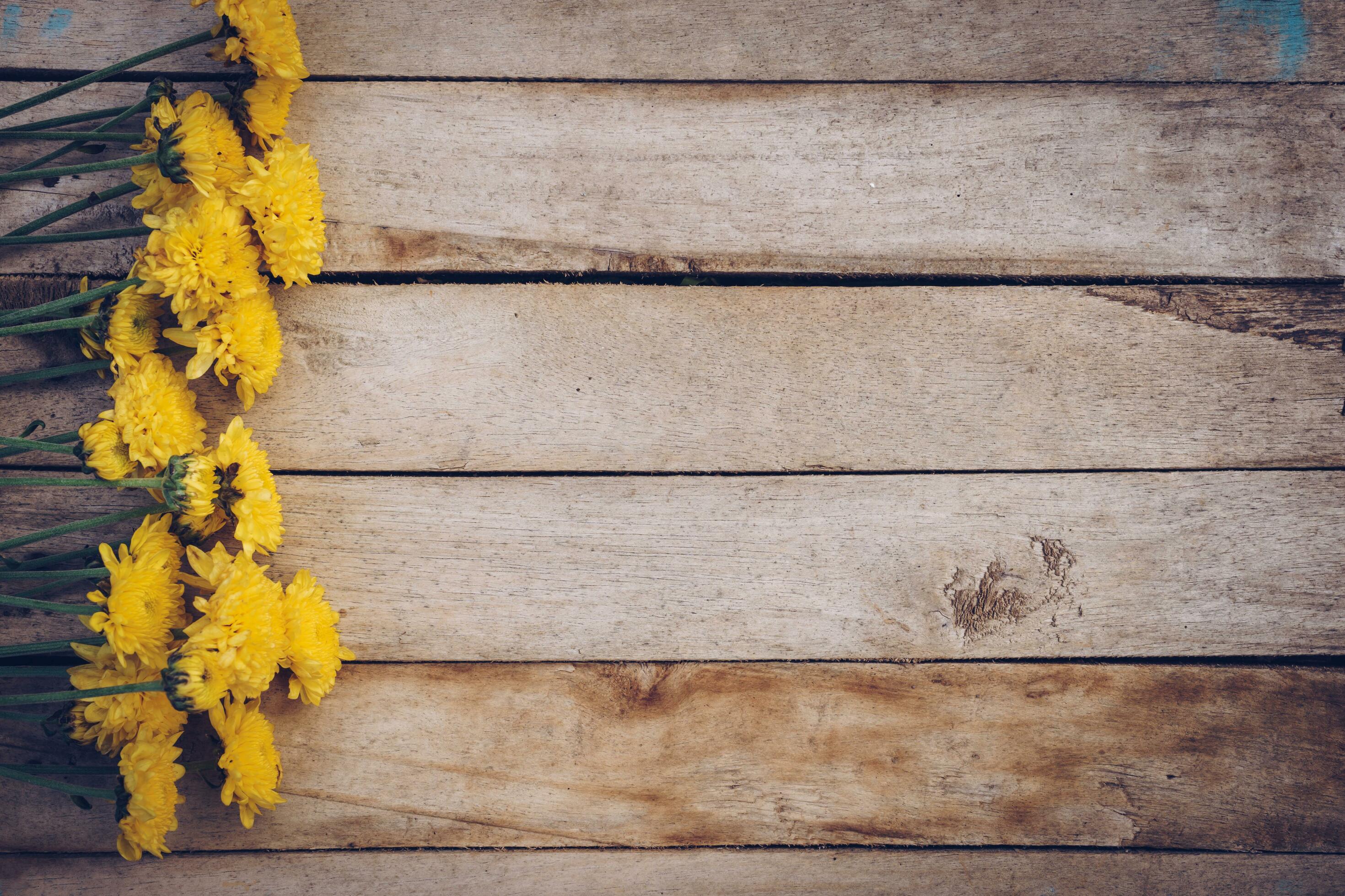 Yellow flowers of bouquet, top view on wooden background texture with copy space Stock Free