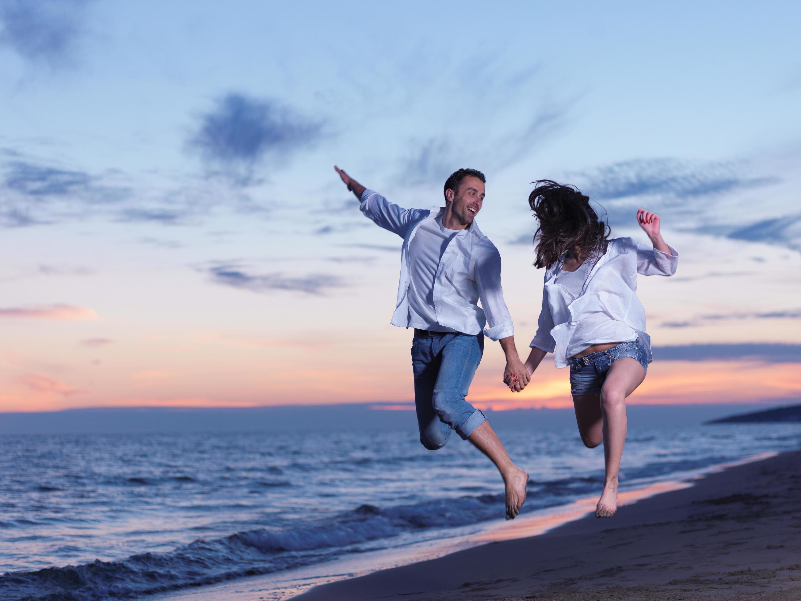 young couple on beach have fun Stock Free