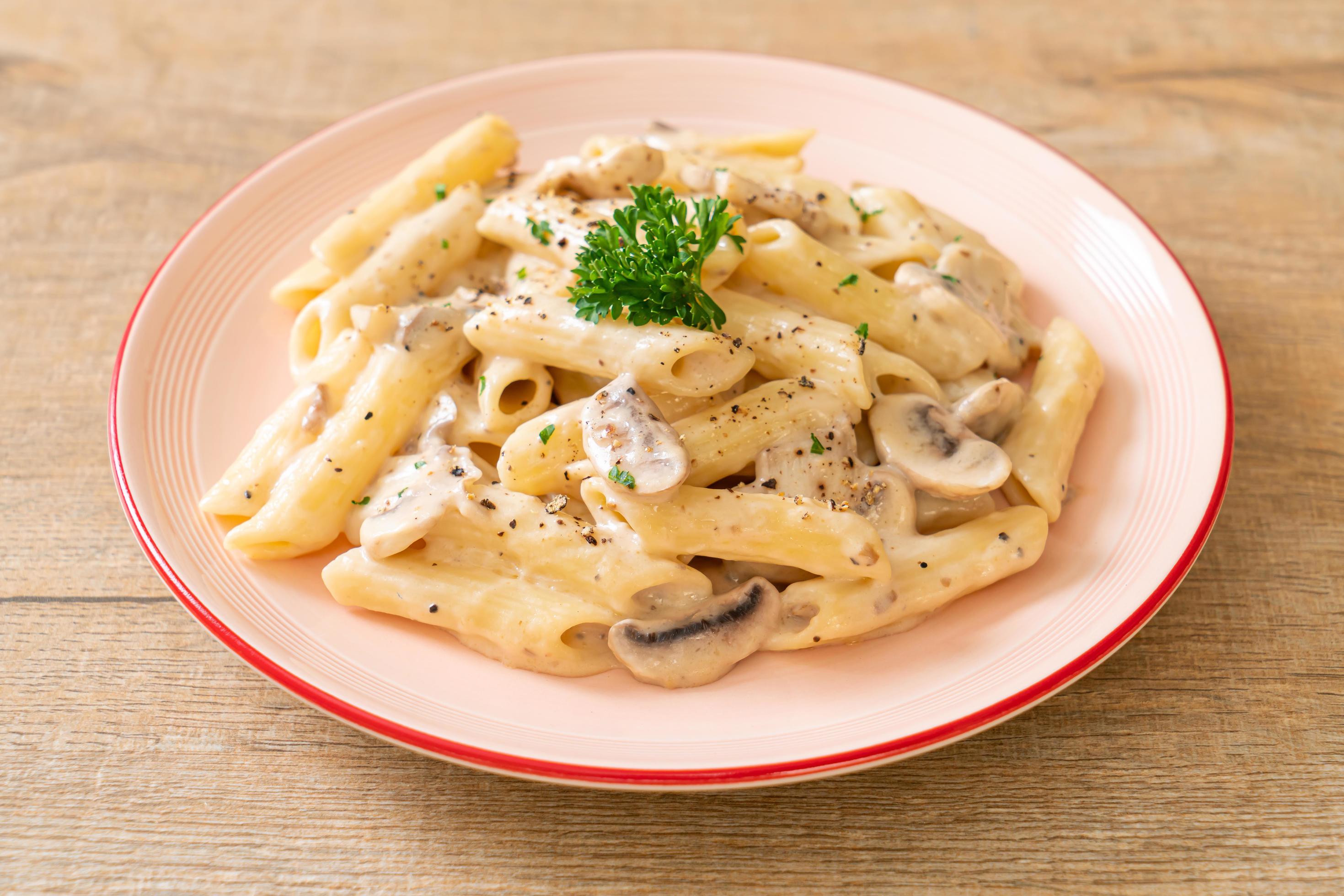 Penne pasta carbonara cream sauce with mushroom – Italian food style Stock Free