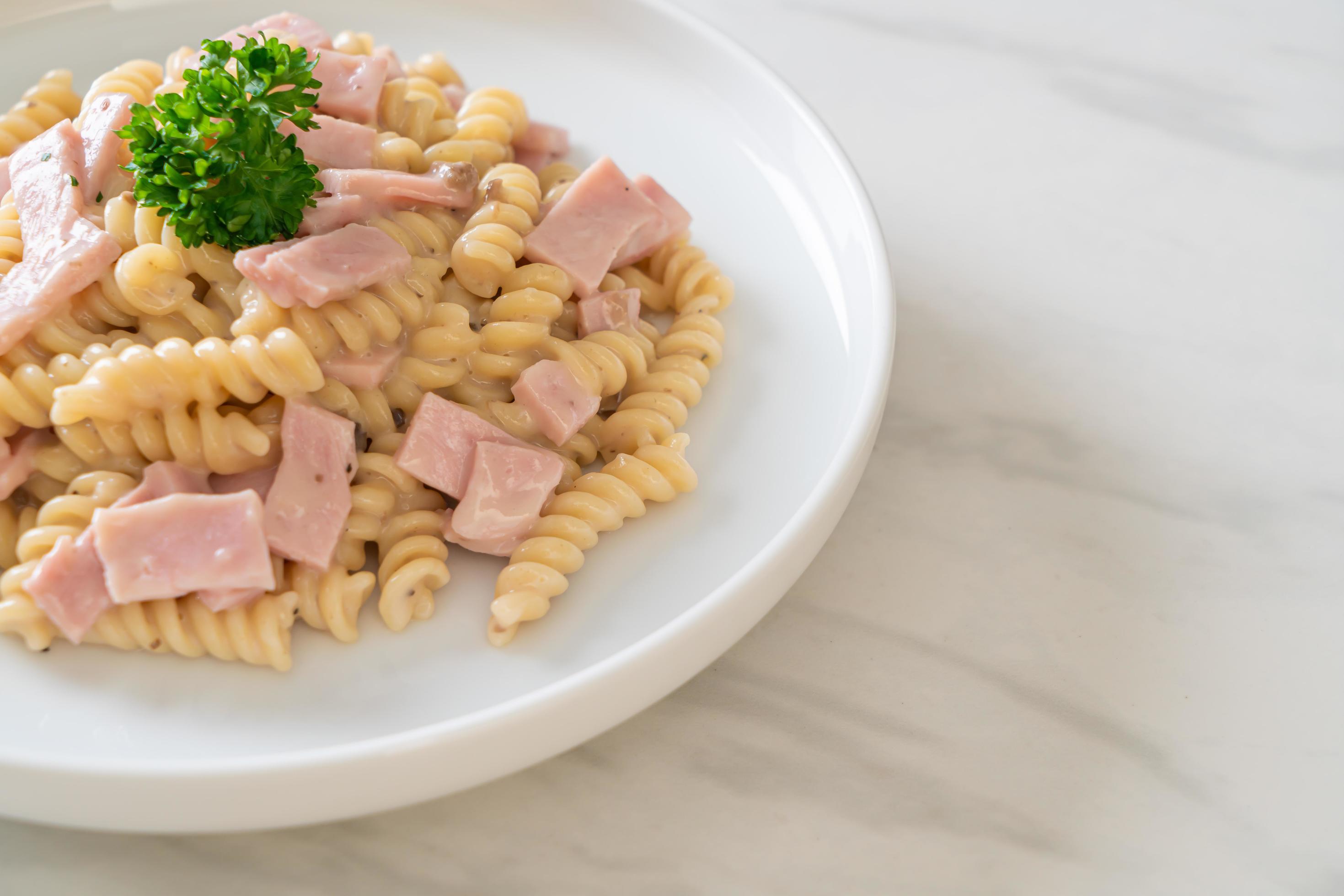 Spirali or spiral pasta mushroom cream sauce with ham – Italian food style Stock Free