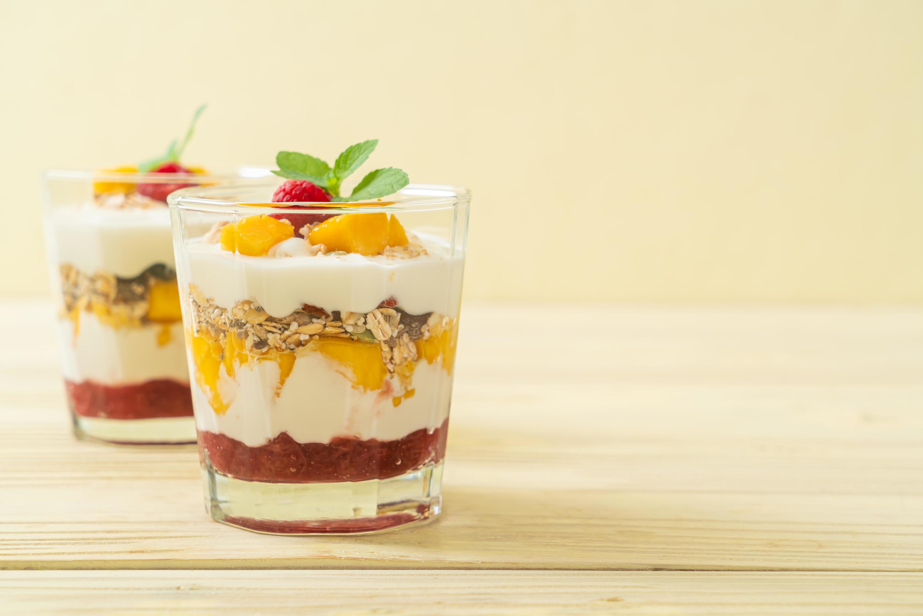 Homemade fresh mango and fresh raspberry with yogurt and granola – healthy food style Stock Free