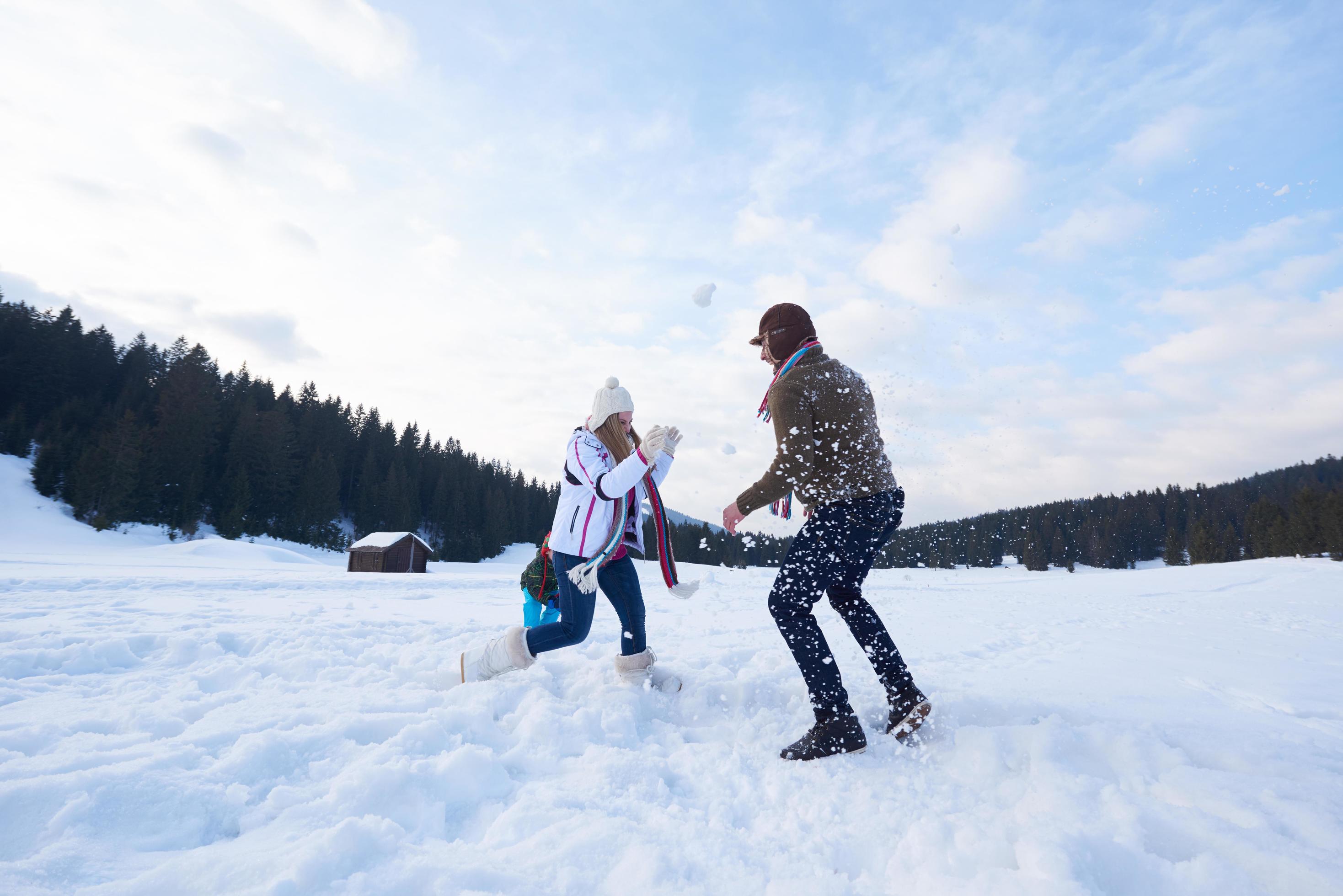 happy family playing together in snow at winter Stock Free