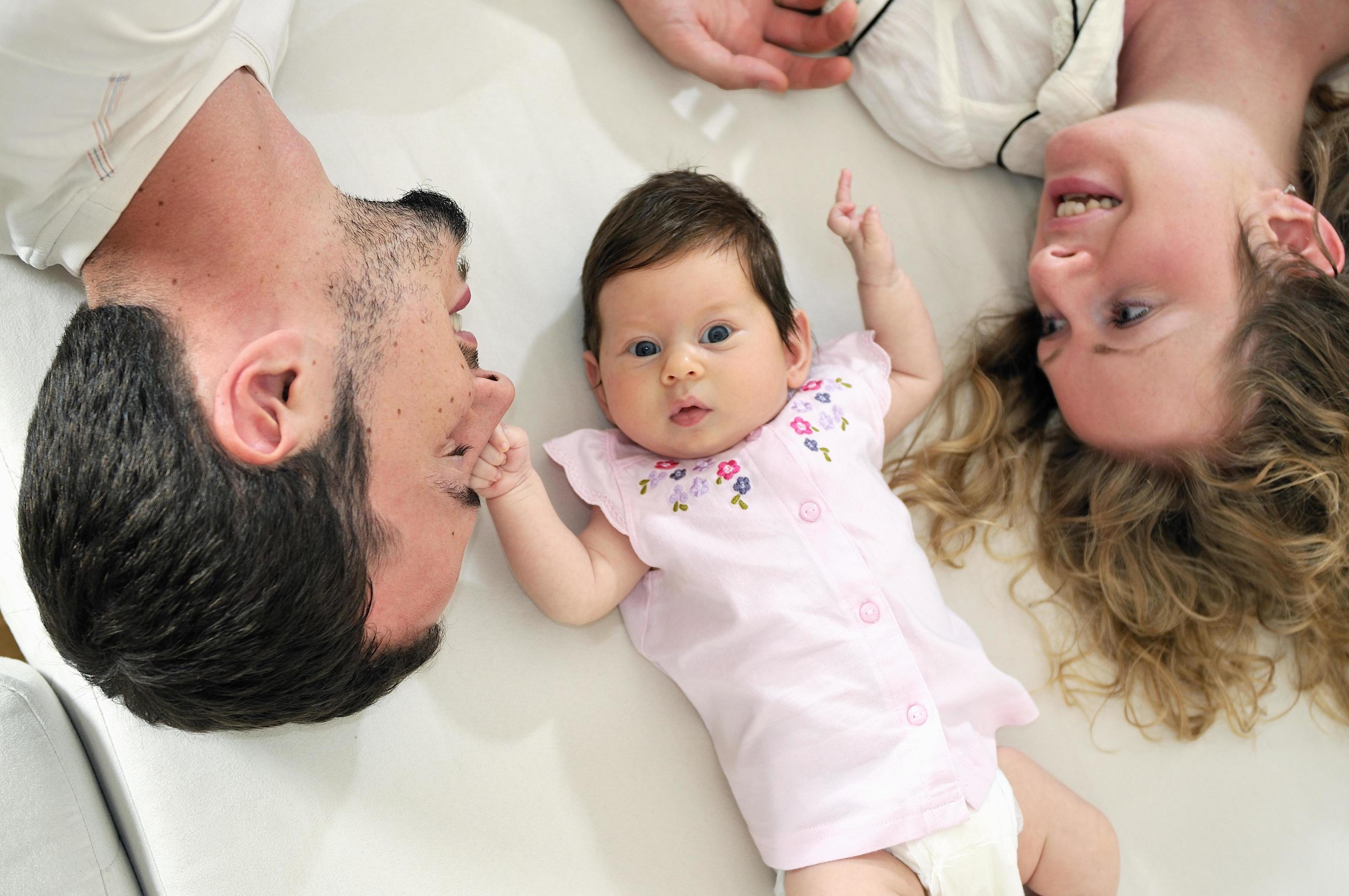 indoor portrait with happy young family and cute little babby Stock Free