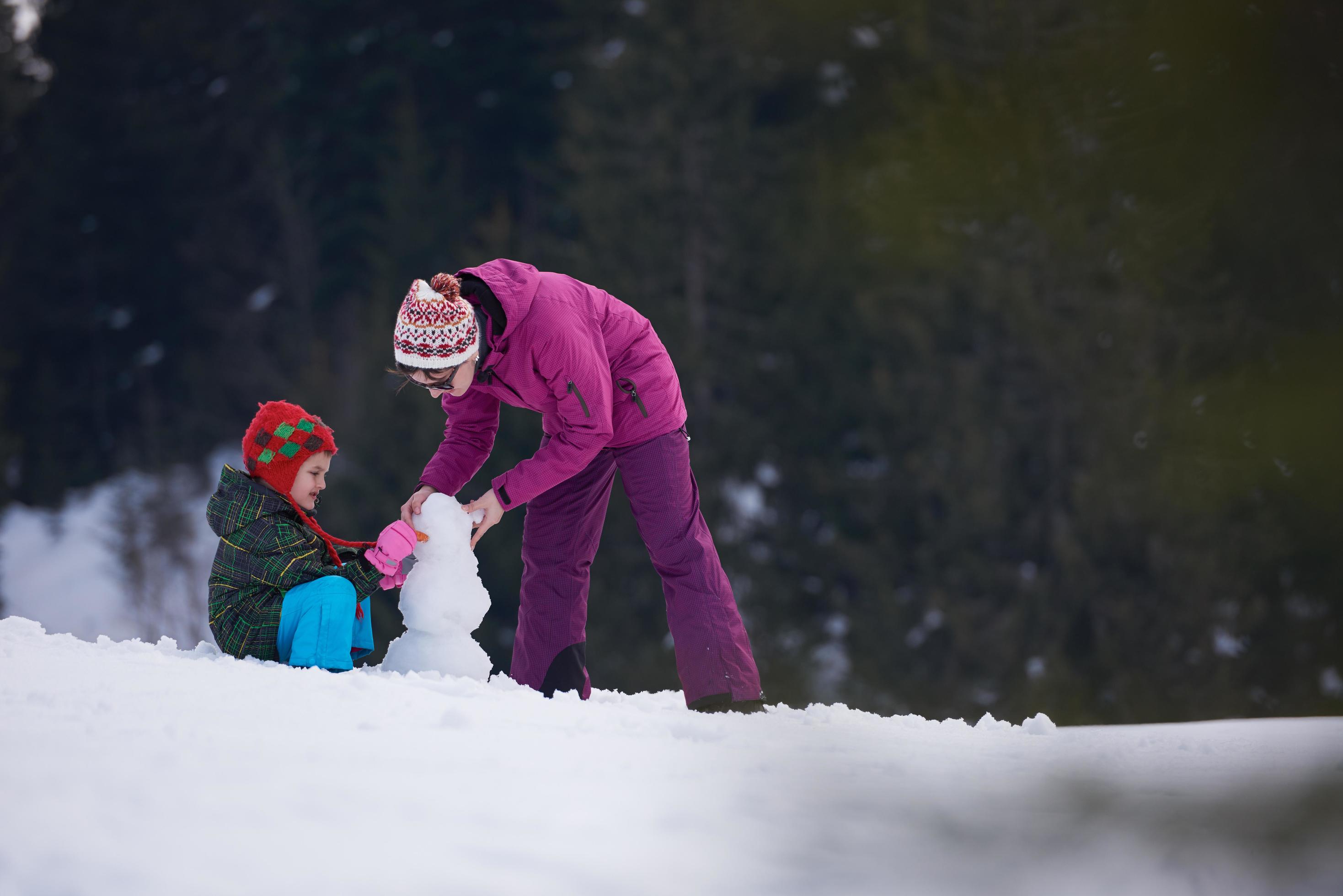 happy family building snowman Stock Free