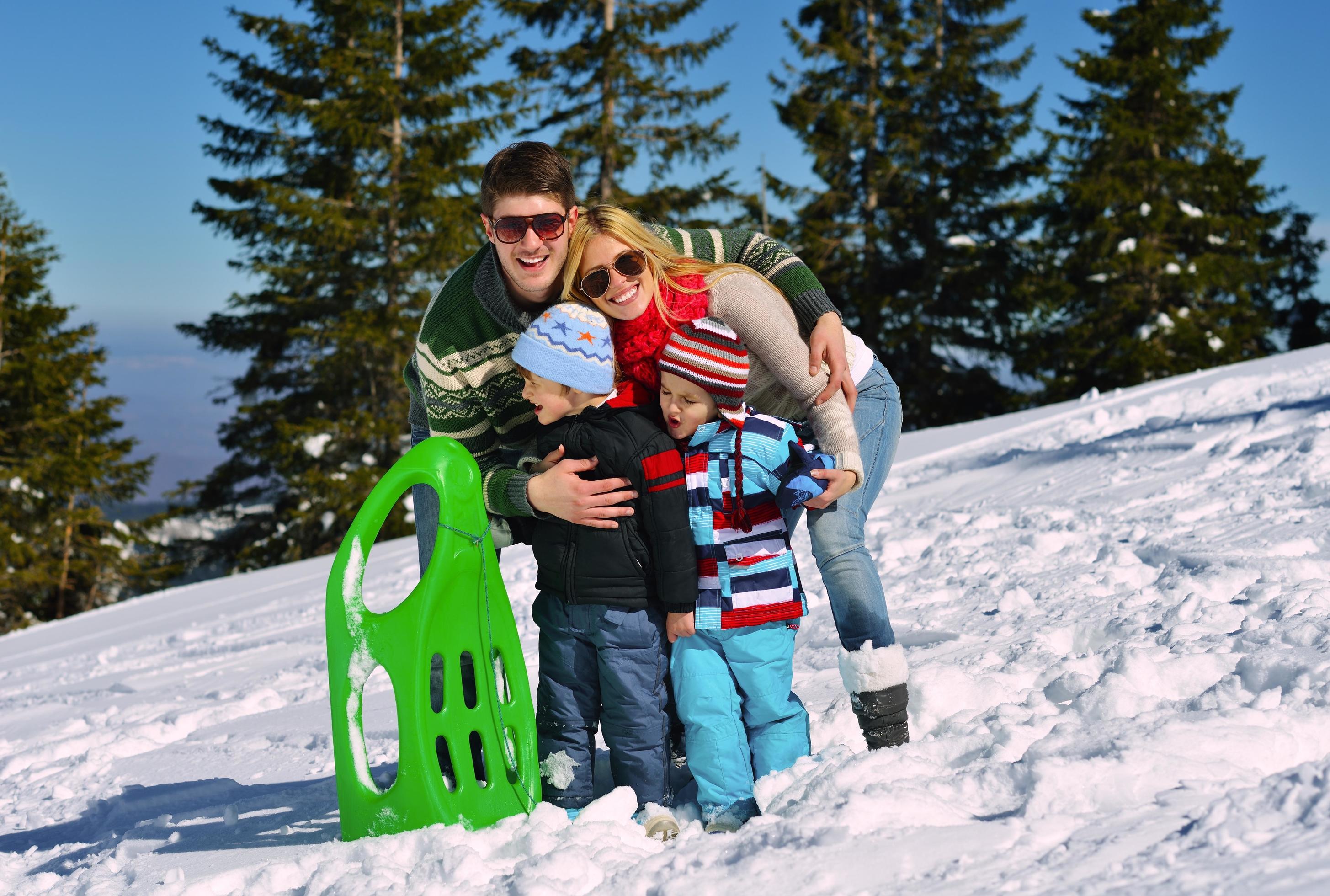 family having fun on fresh snow at winter Stock Free