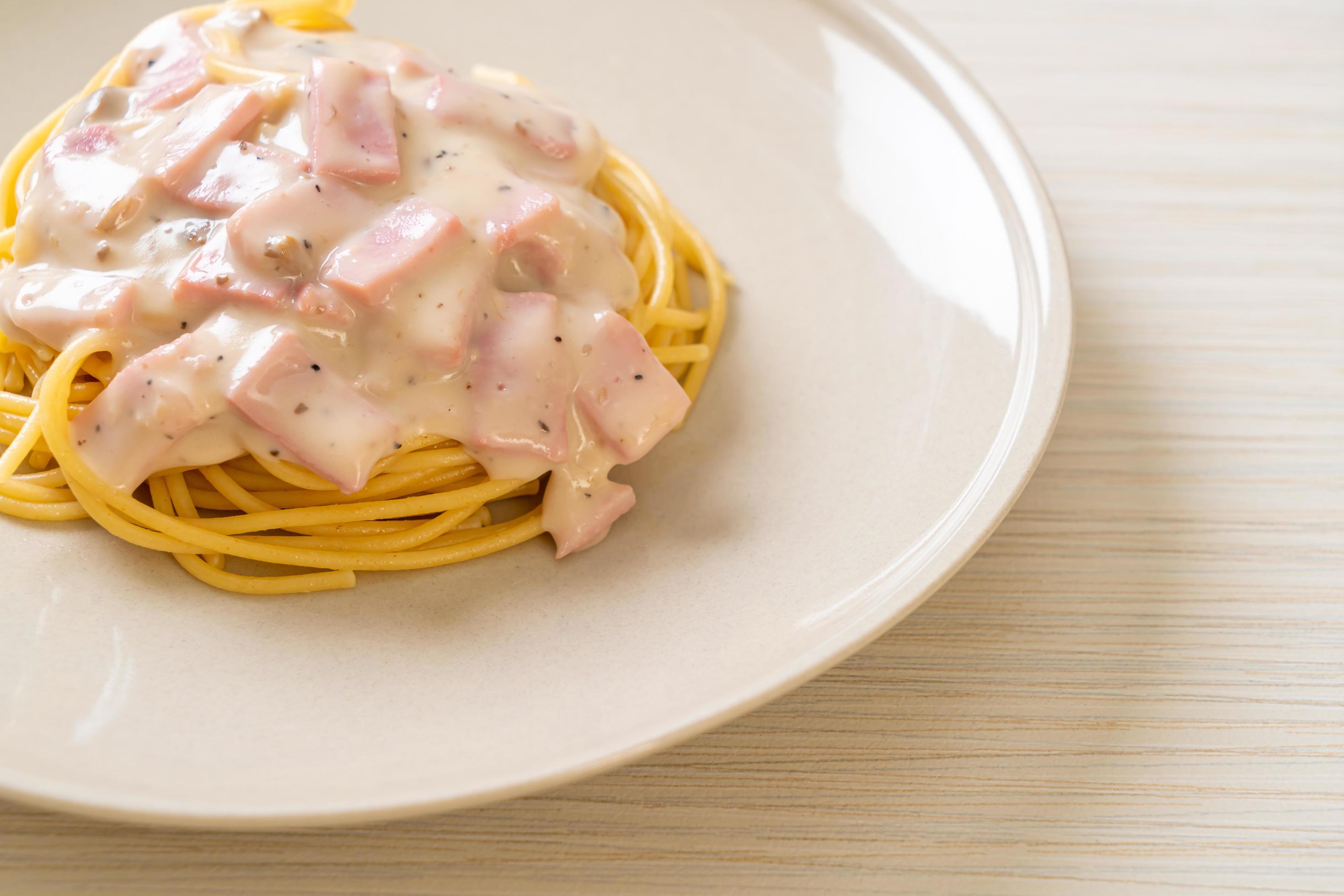 Homemade spaghetti white cream sauce with ham – Italian food style Stock Free