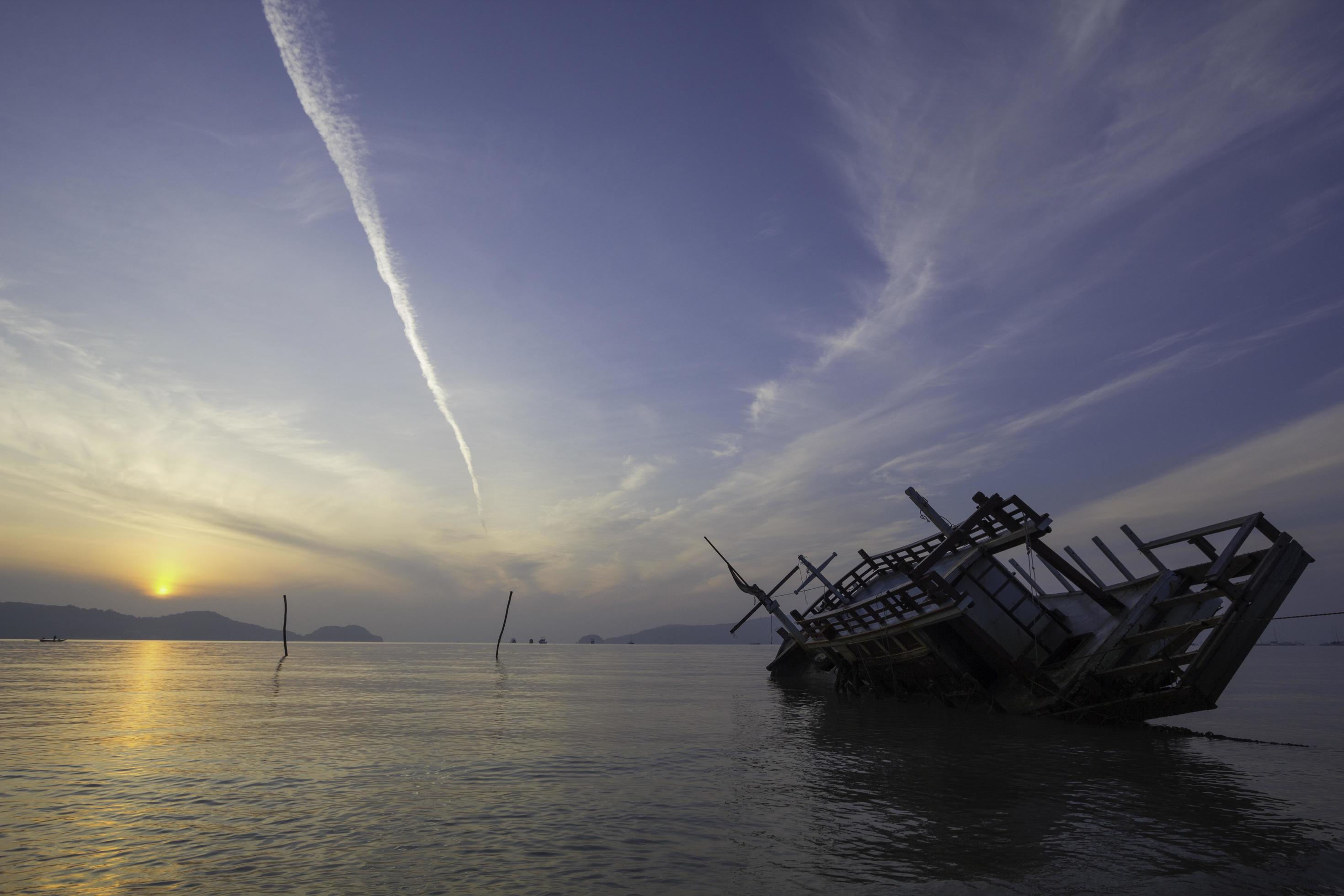 
									Sinking boat, view at sunrise Stock Free