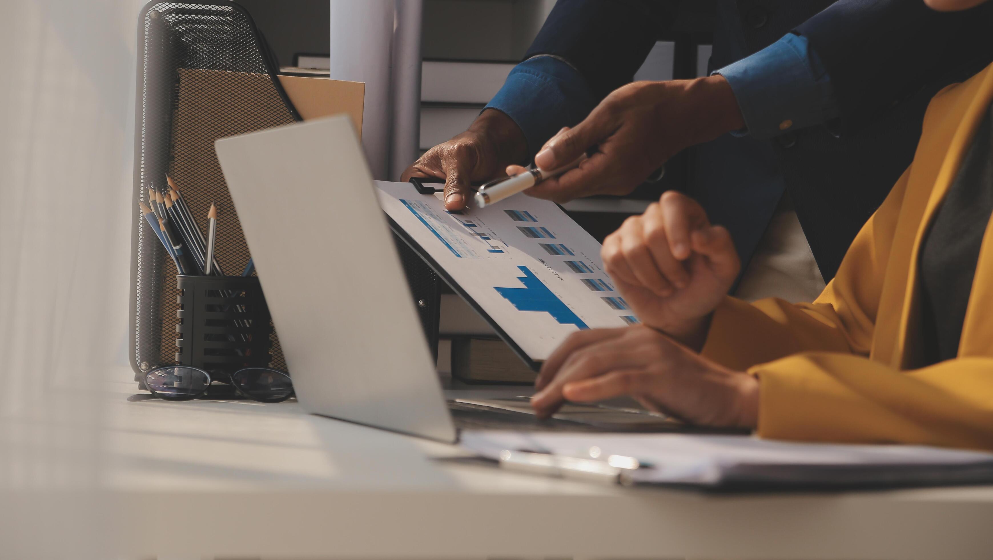 Close up of Business team analyzing income charts and graphs with modern laptop computer. Business analysis and strategy concept. Stock Free