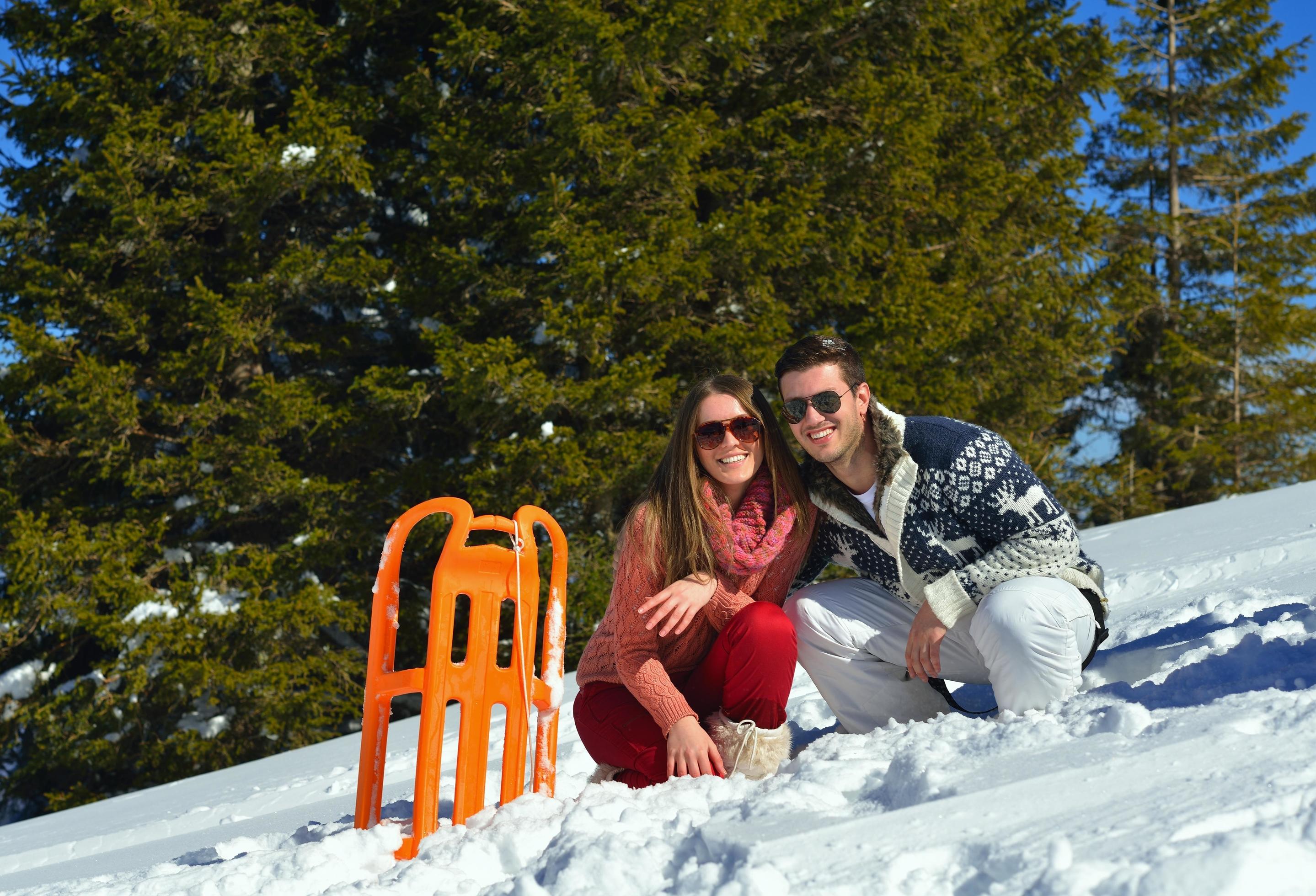 family having fun on fresh snow at winter vacation Stock Free