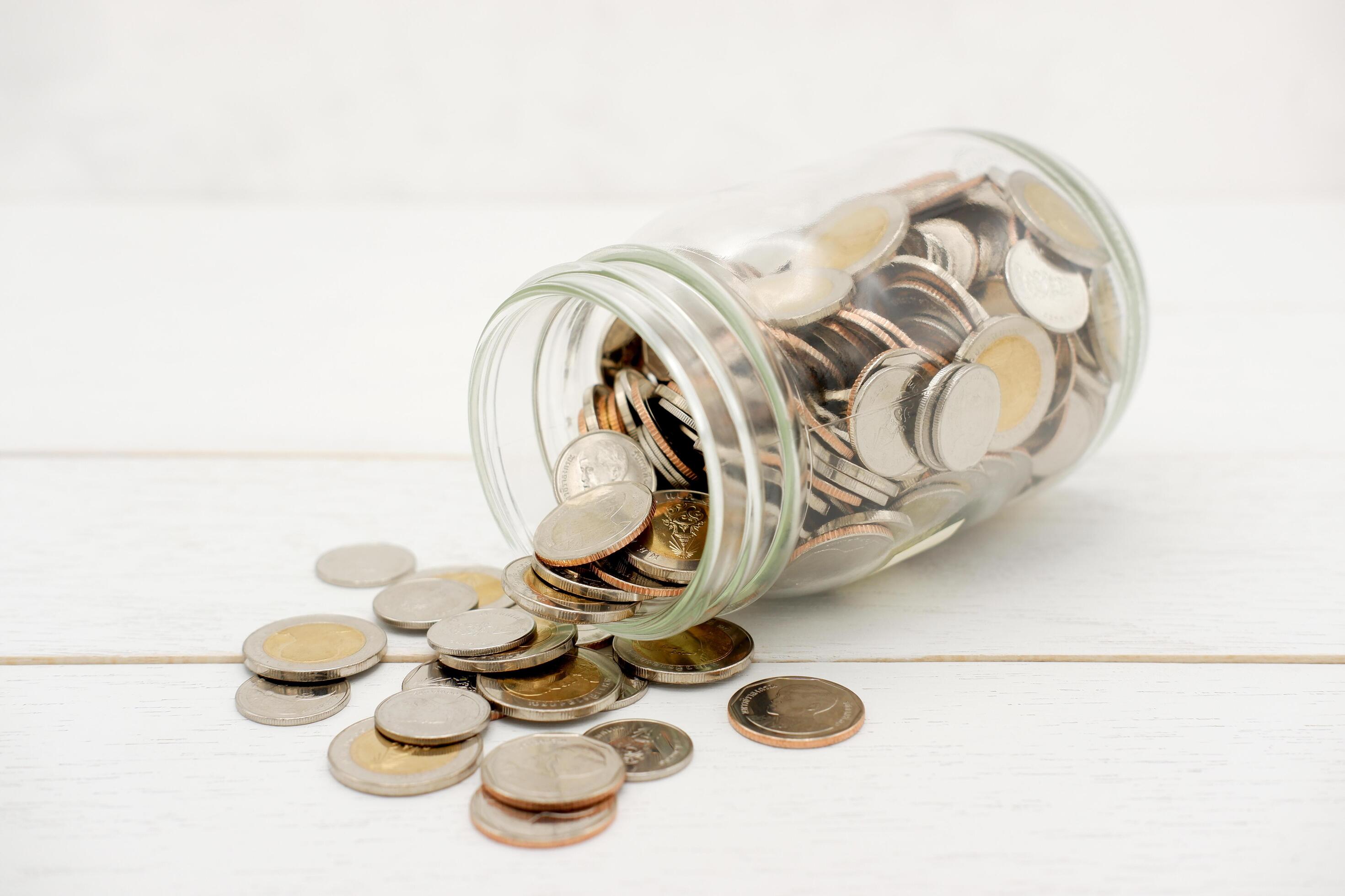 Thai Baht coins in a glass jar. Business and finance concept. Stock Free