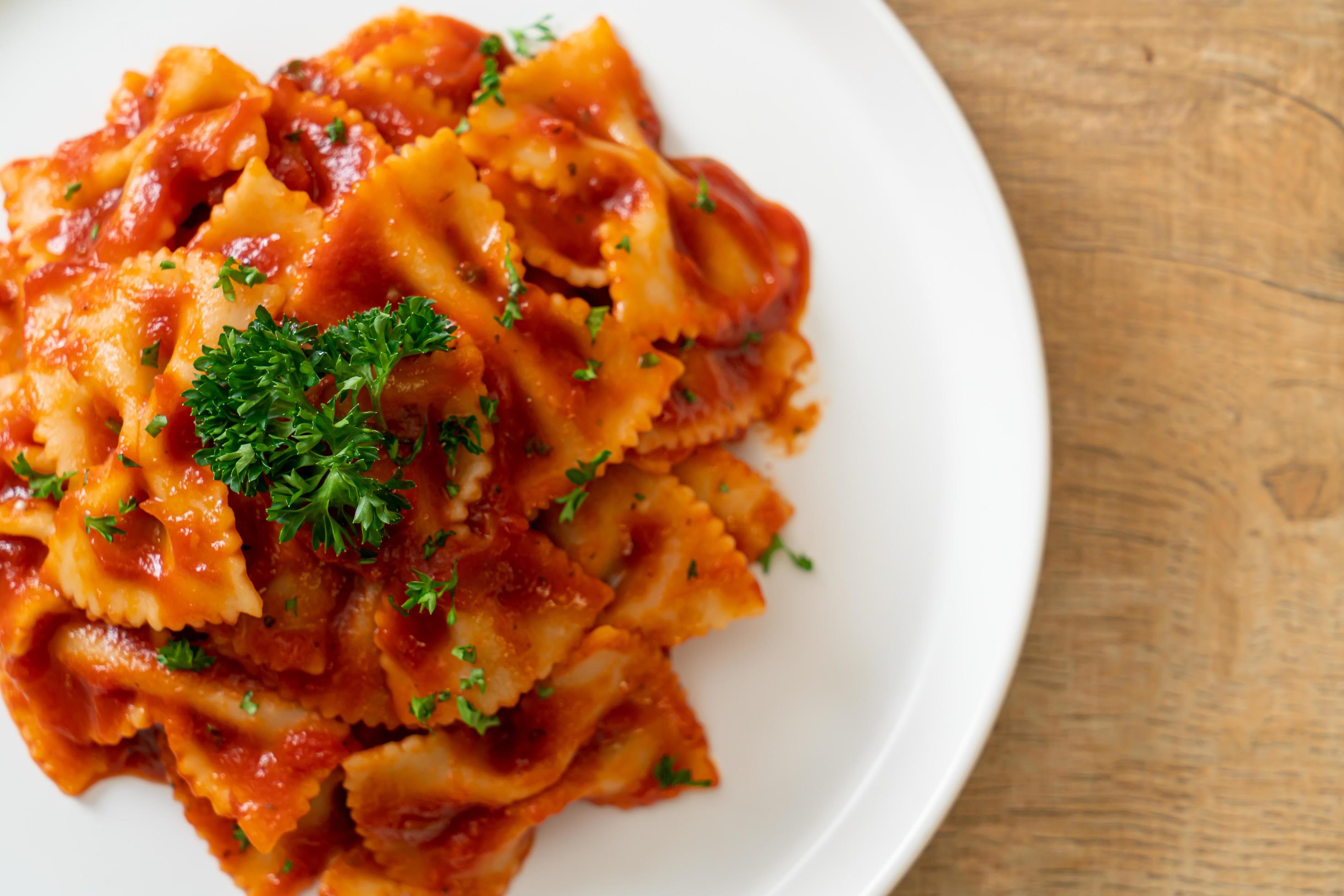 Farfalle pasta in tomato sauce with parsley – Italian food style Stock Free