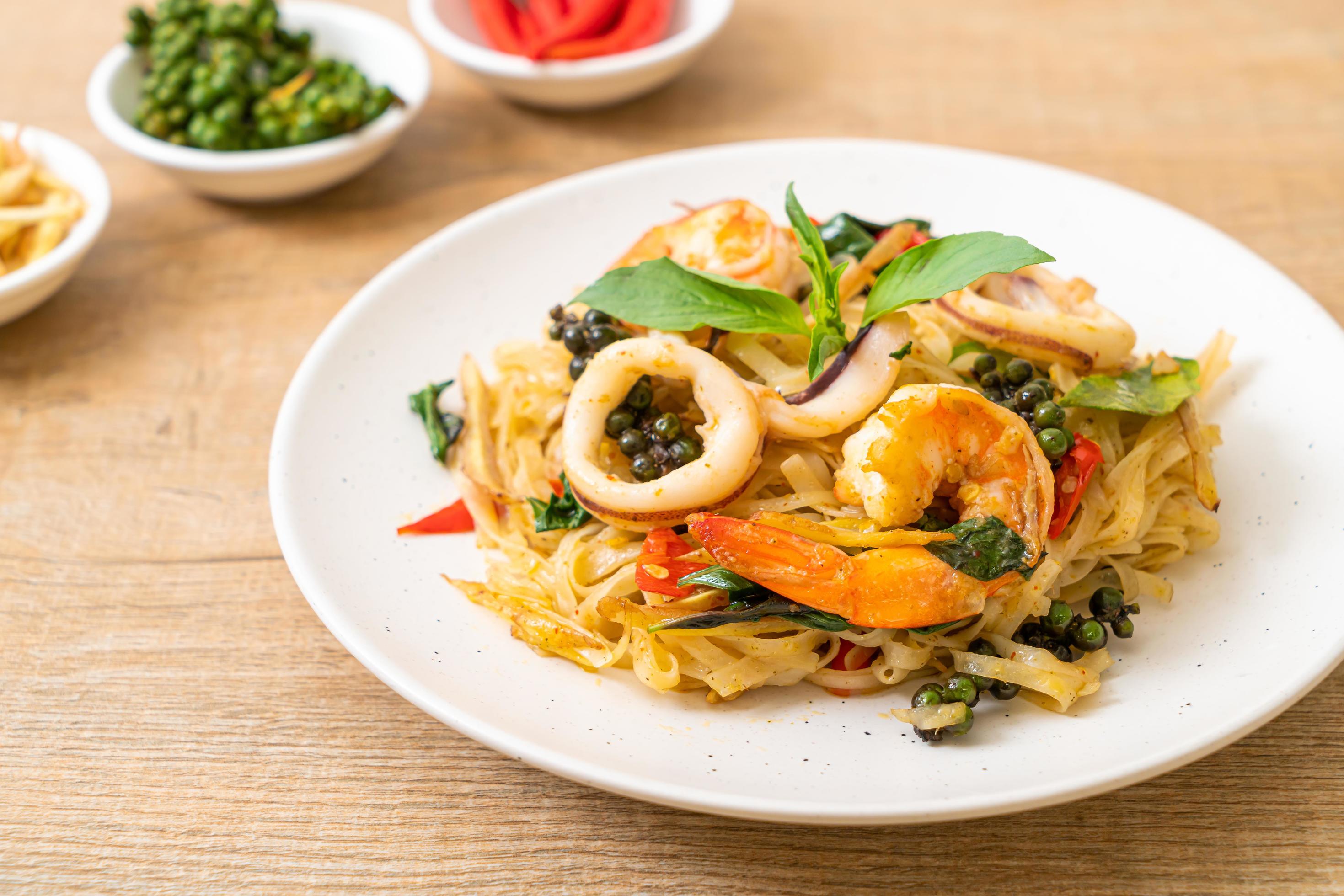 Stir-fried spicy noodles with sea food, or Pad Cha Talay – Thai food style Stock Free