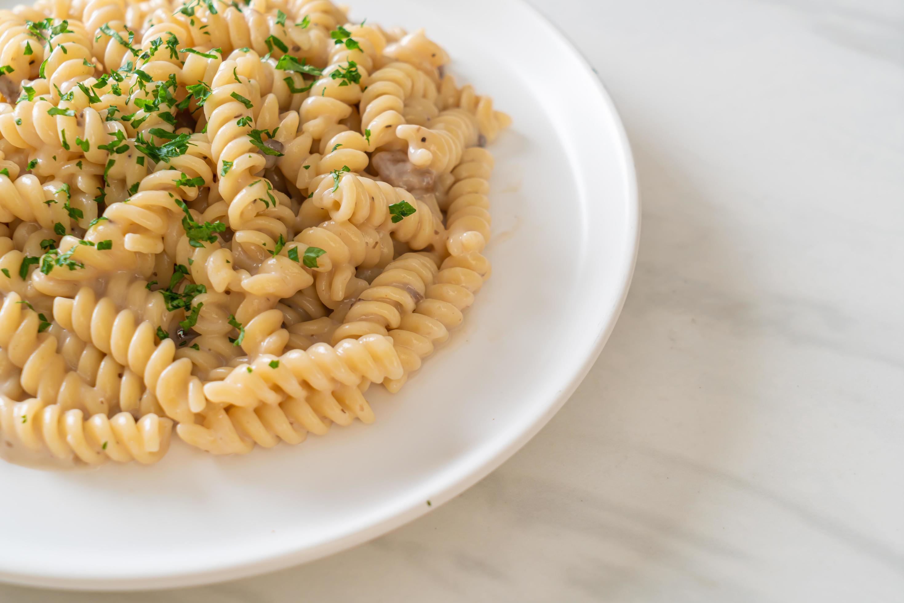 Spirali or spiral pasta mushroom cream sauce with parsley – Italian food style Stock Free