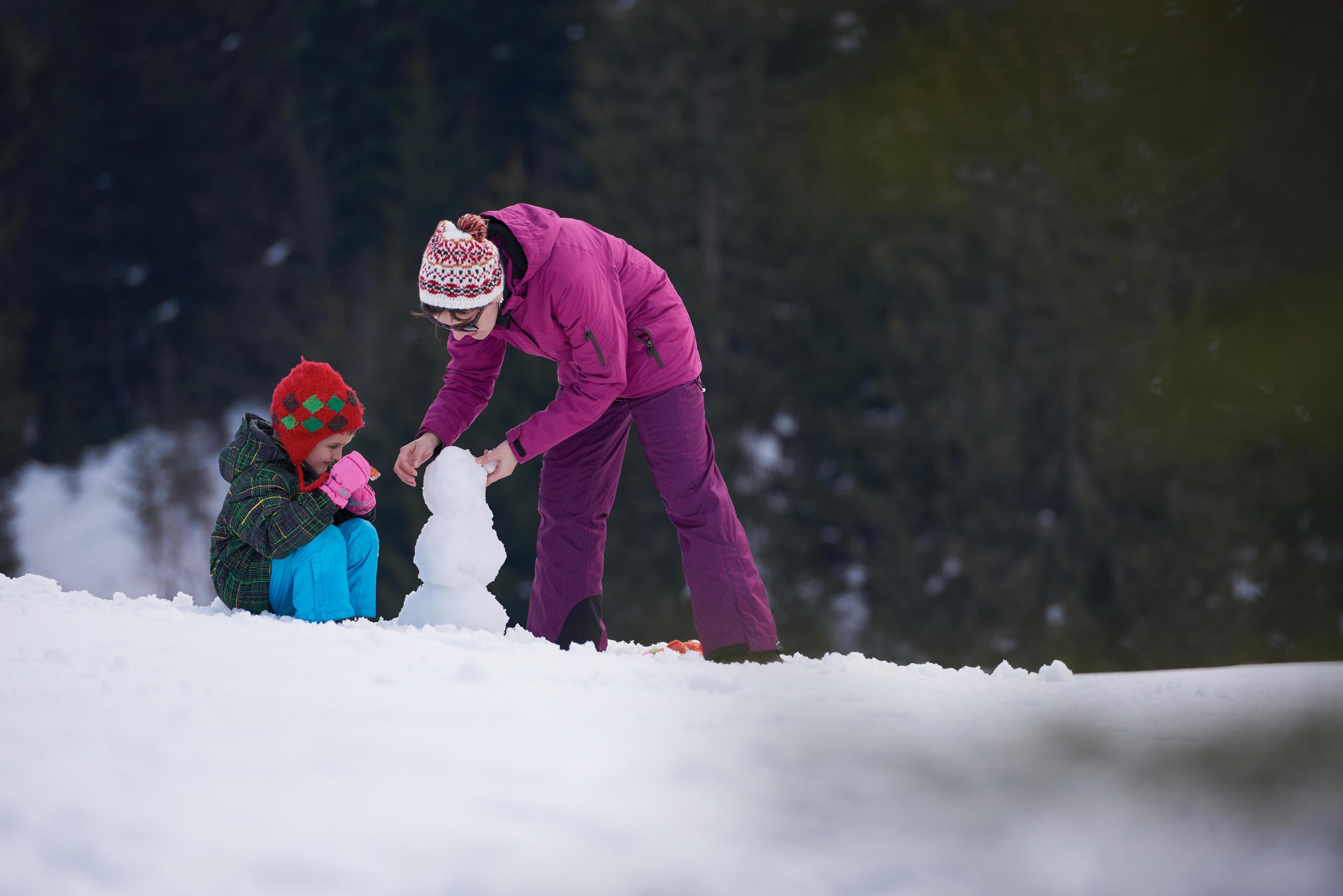 happy family building snowman Stock Free