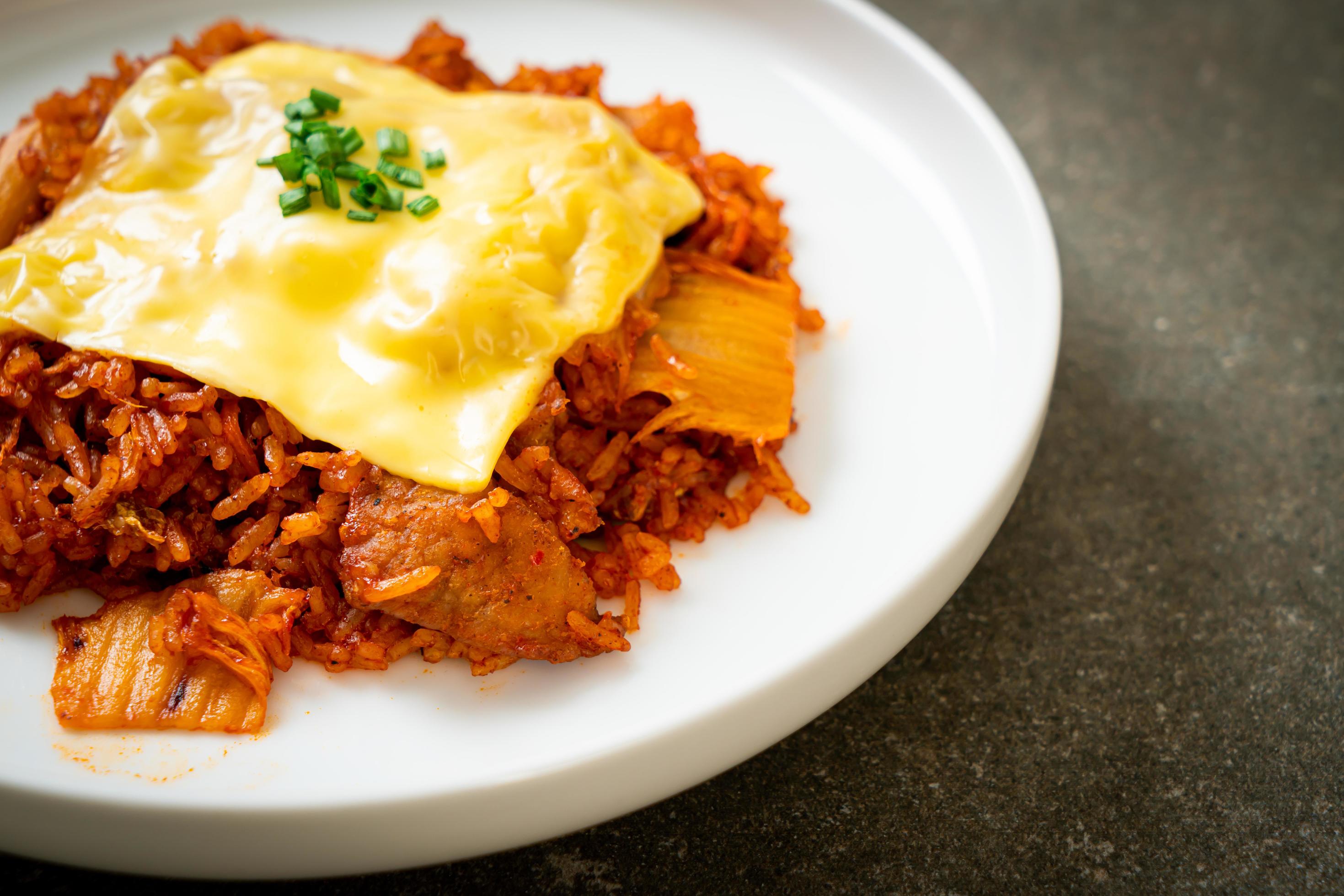 Kimchi fried rice with pork and topped cheese – Asian and fusion food style Stock Free