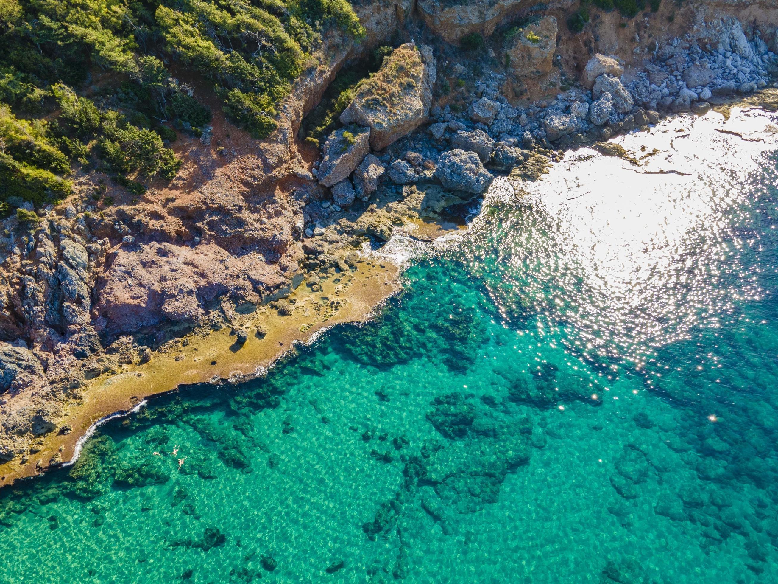 sea and rocky from the air. bird’s eye view over the blue sea Stock Free