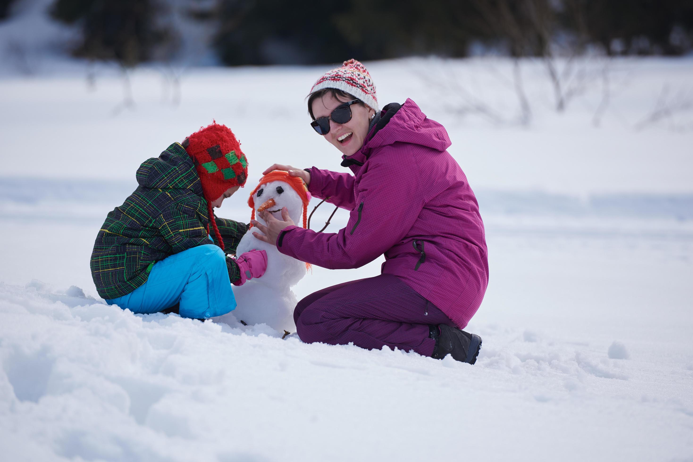 happy family building snowman Stock Free