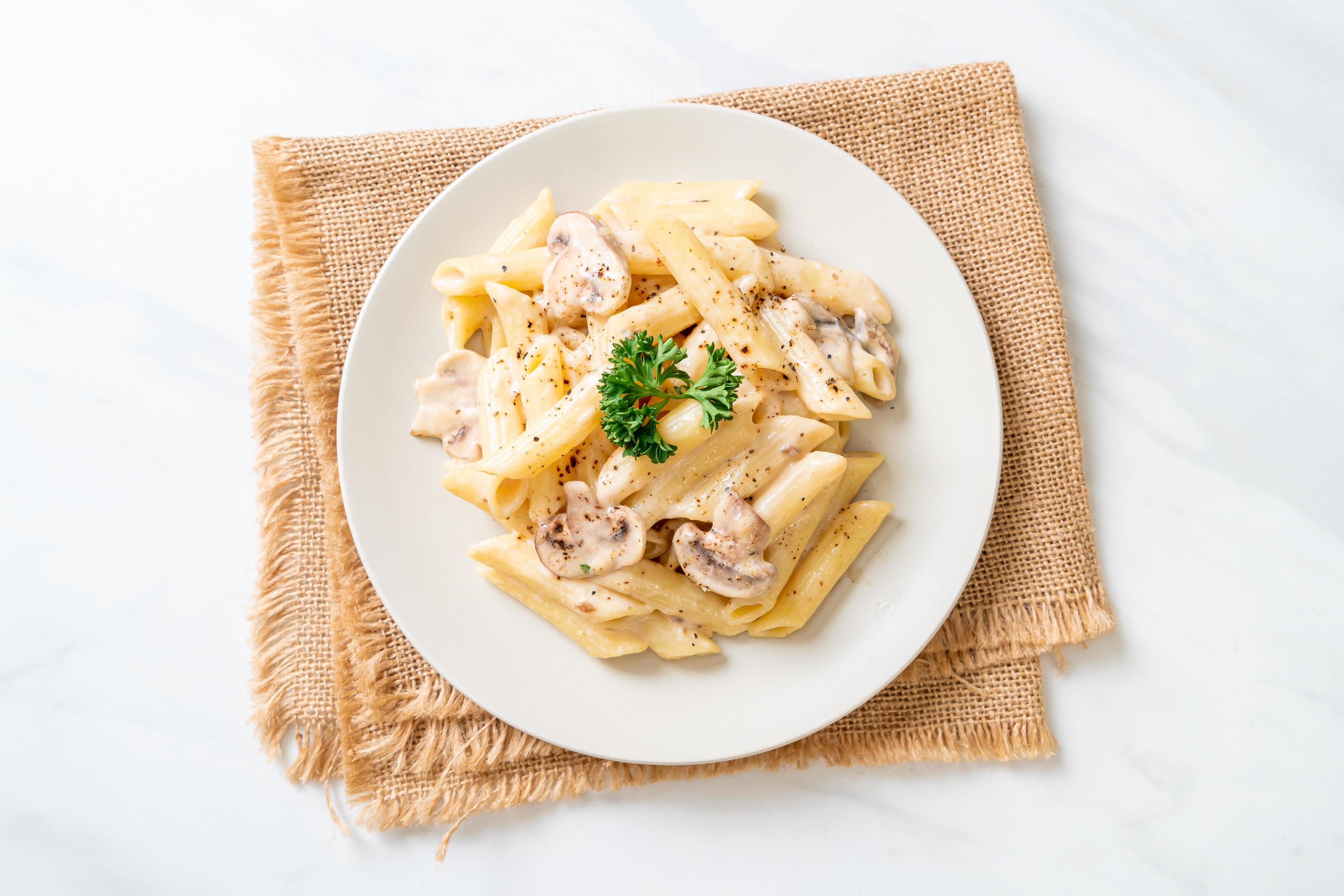 Penne pasta carbonara cream sauce with mushroom – Italian food style Stock Free