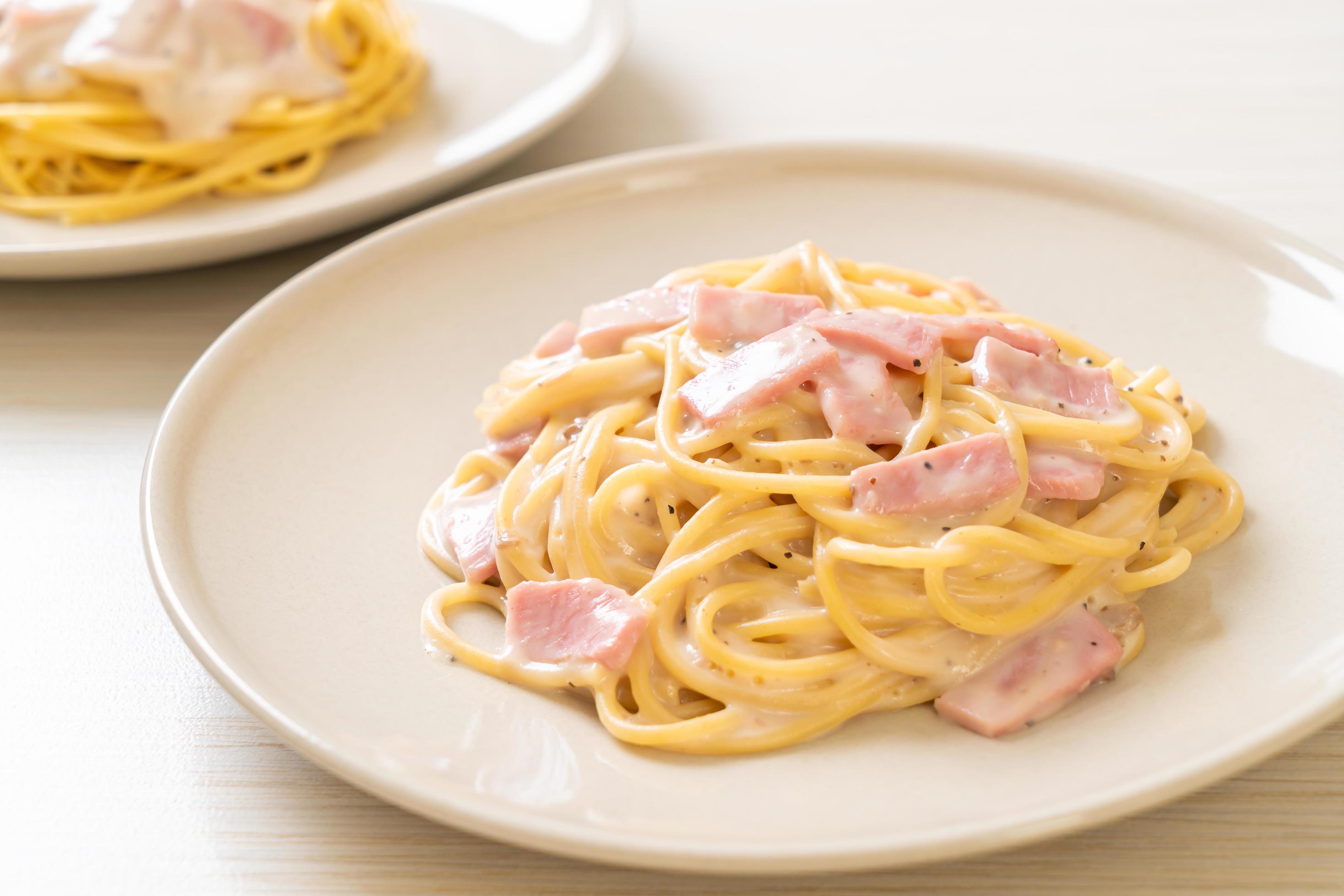 Homemade spaghetti white cream sauce with ham – Italian food style Stock Free